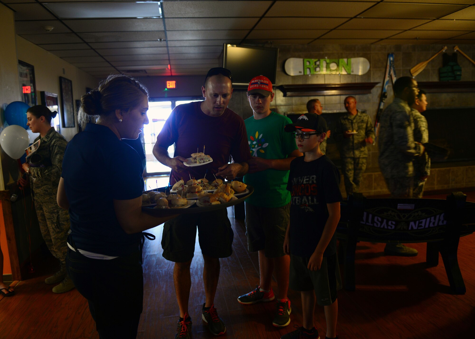 Air Commandos eye a sampling platter from the Tailgate Sports Lounge at the Drop Zone June 4, 2015 at Cannon Air Force Base, N.M. One of the many upgrades made to the Drop Zone during its renovation, the Tailgate Sports Lounge is a dine-in restaurant owned and operated entirely by the 27th Speical Operations Force Support Squadron. (U.S. Air Force photo/Airman 1st Class Shelby Kay-Fantozzi)