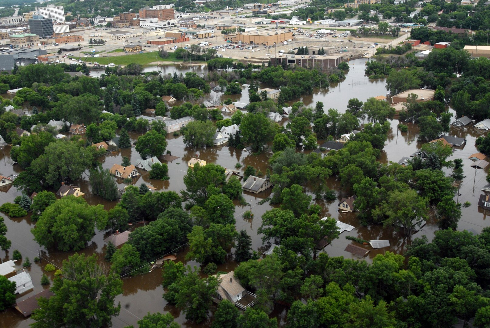 Floodwaters overwhelmed several neighborhoods in the Minot, N.D., area, reaching the south part of the city, pictured in the background here June 26, 2011. The National Guard and civilian agencies were able to construct levees to hold back the water and keep it from destroying more properties.