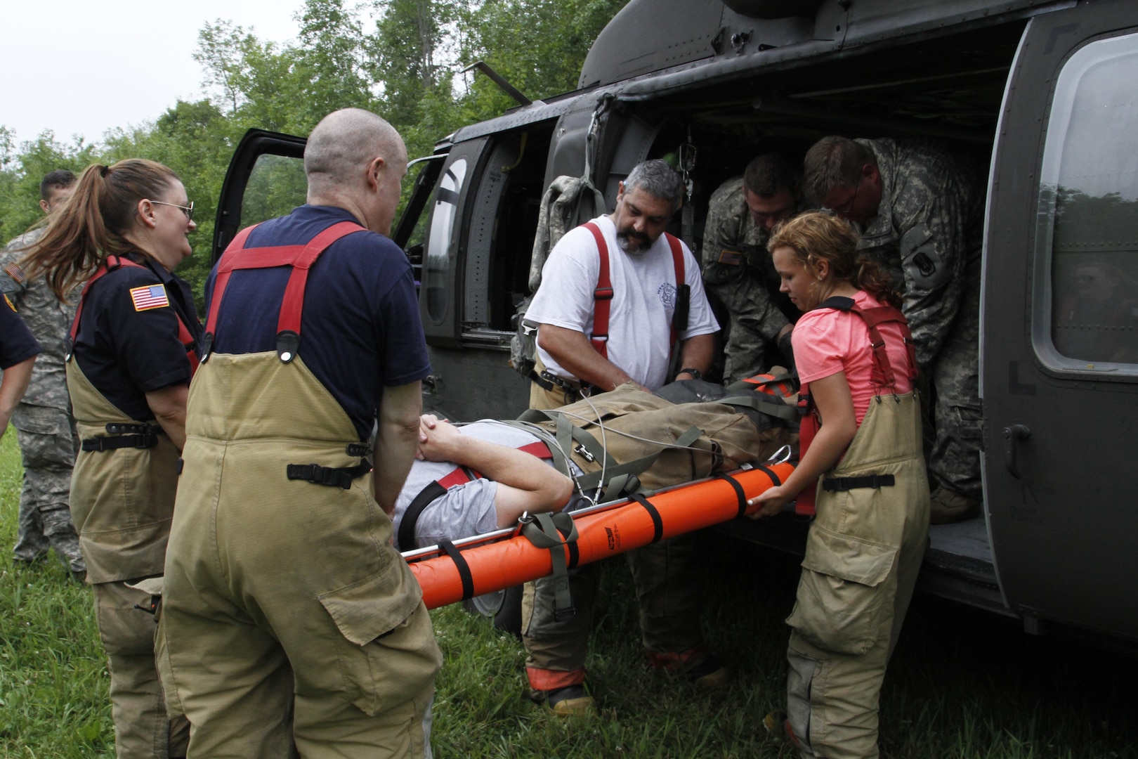 Firefighters with the West Monroe Volunteer Fire Department load a casualty onto a UH-60 Black Hawk helicopter with the help of Sgt. Michael Butler, a flight medic, and Spc. Brian Watson, a crew chief, both with Company F, 1st Battalion, 169th General Support Aviation Battalion, during a cold load training exercise in Cicero, N.Y., Saturday, July 18, 2015. (U.S. Army National Guard  photo by Sgt. Jonathan Monfiletto/Released)