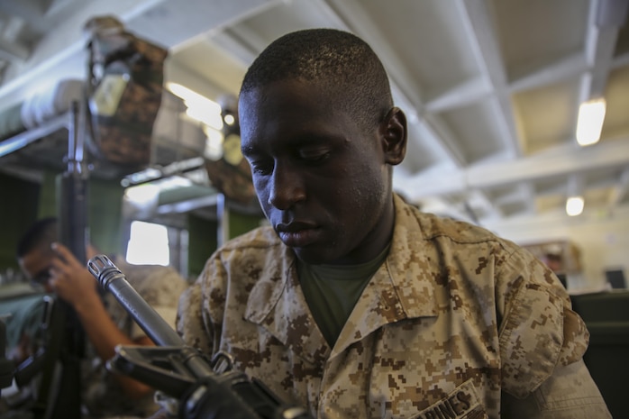 Private Akeem A. White, Echo Company, 2nd Recruit Training Battalion, cleans his weapon prior to the Battalion Commander’s Inspection at Marine Corps Recruit Depot San Diego, July 20. Following recruit training, White will move on to the School of Infantry Marine Corps Base Camp Pendleton, Calif., where he will pursue his career as an infantryman. He plans on finishing his degree and making a career in of the Marine Corps.  White is a native of Victorville, Calif., and was recruited out of Recruiting Station San Diego. Today, all males recruited from west of the Mississippi are trained at MCRD San Diego. The depot is responsible for training more than 16,000 recruits annually. Echo Company is scheduled to graduate July 24.