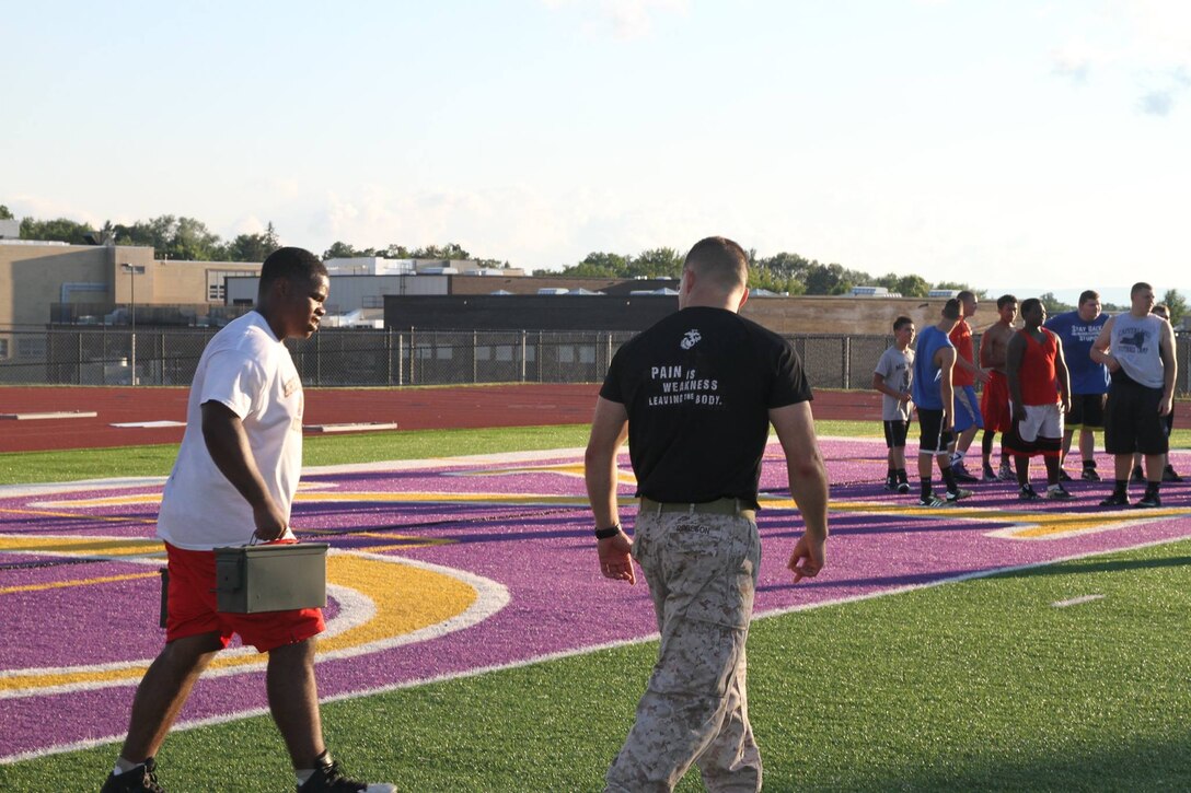 Marines with Recruiting Station Albany, NY, motivate athletes of the Troy High School football team through a circuit course at the school’s football field in Troy, NY, Tuesday, July 21, 2015. The circuit course was the concluding exercise in a leadership seminar the Marines conducted for the football team. 