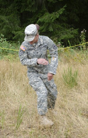 Sgt. 1st Class Patricia Krumnauer, chief of the Correctional Supervision Branch, 42nd Military Police Brigade, 593rd Sustainment Brigade, darts away instantly after getting engaged by the Active Denial System at Joint Base Lewis-McChord, Wash., Aug. 6. The Joint Non-Lethal Weapons Directorate conducted the training exercise to expose Soldiers to a weapon system that supports a full spectrum of operations, such as crowd dispersal, checkpoint security, and suppression of vehicle operators or occupants.
