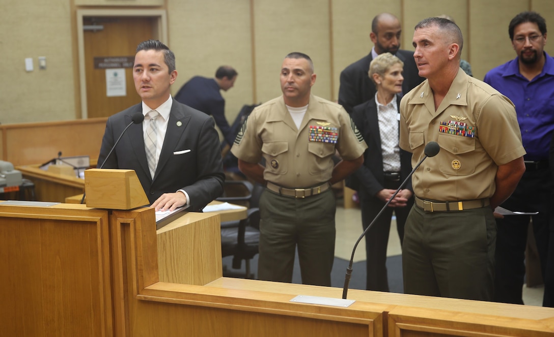 Chris Cate, San Diego councilmember of District 6, presents the Marine Corps Air Station Miramar Single Marine Program 20th Anniversary proclamation during a council meeting at the City Administration Building, San Diego, July 21. The SMP received recognition for contributing more than 300 hours of volunteer effort to the city of San Diego. (U.S. Marine Corps photo by Lance Cpl. Kimberlyn Adams/Released)