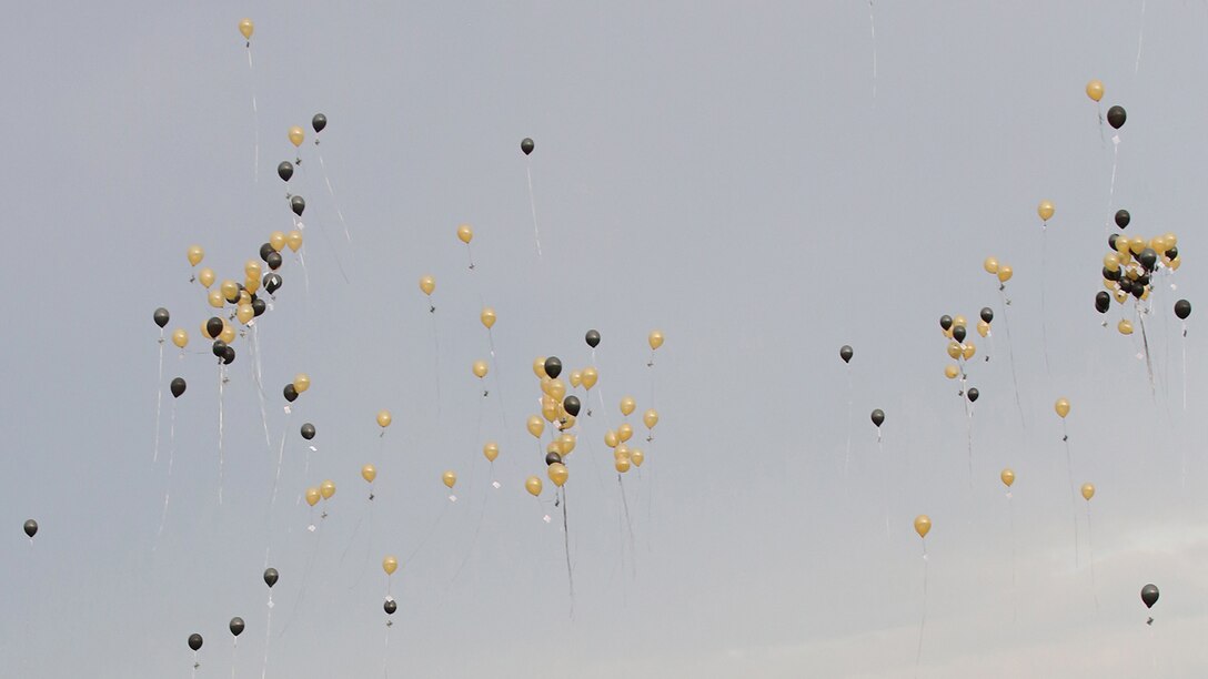 Hundreds of balloons float into the air during Lance Cpl. Squire Wells memorial at Sprayberry High School in Marietta, Georgia, July 21, 2015. Wells was one of five service members to be killed when a gunman entered the Naval Operational Support Center and Marine Corps Reserve Center on July 16, 2015. To honor Wells and ensure his mother receives all the support she needs each balloon carried a memorial card that will reminded those who find the card to take a moment to let Cathy Wells know she is not alone. 