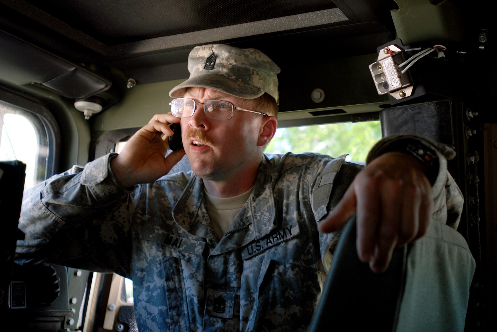 Army 1st Sgt. Scott Mai, 164th Engineer Battalion, Headquarters and
Headquarters Company first sergeant, checks in with his family while out on
patrol in Minot, N.D., June 29, 2011. Mai had just entered a flooded
neighborhood to escort citizens who were reentering their homes without the
proper consent. The evacuation zones are still unsafe for residents to enter,
according to authorities.