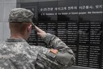 In this photo file, Pvt. Wildes, a Soldier from the Headquarters and Headquarters Company, 2nd Combat Aviation Brigade, took time to salute a part of the memorial July 10 at a fallen heroes ceremony on Gaemi Hill in Sejong, South Korea. The wall had been dedicated to the 428 U.S. Soldier's names who had given the ultimate sacrifice at the Battle of Gaemi Hill during the Korean War.