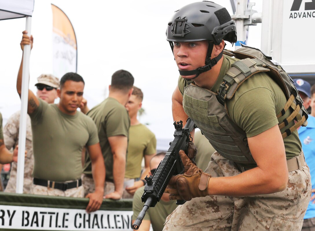 Marines and Sailors competed in the Military Battle Challenge, Commanding General’s Cup competition at the 11 Area shopping center, July 22. Competitors raced to complete a series of tasks such as scaling a rope net, moving five 40lb. fuel canisters and shooting laser guns. The Military Battle Challenge is a new obstacle course race that tests competitor’s endurance, strength and marksmanship skills against the clock and each other.