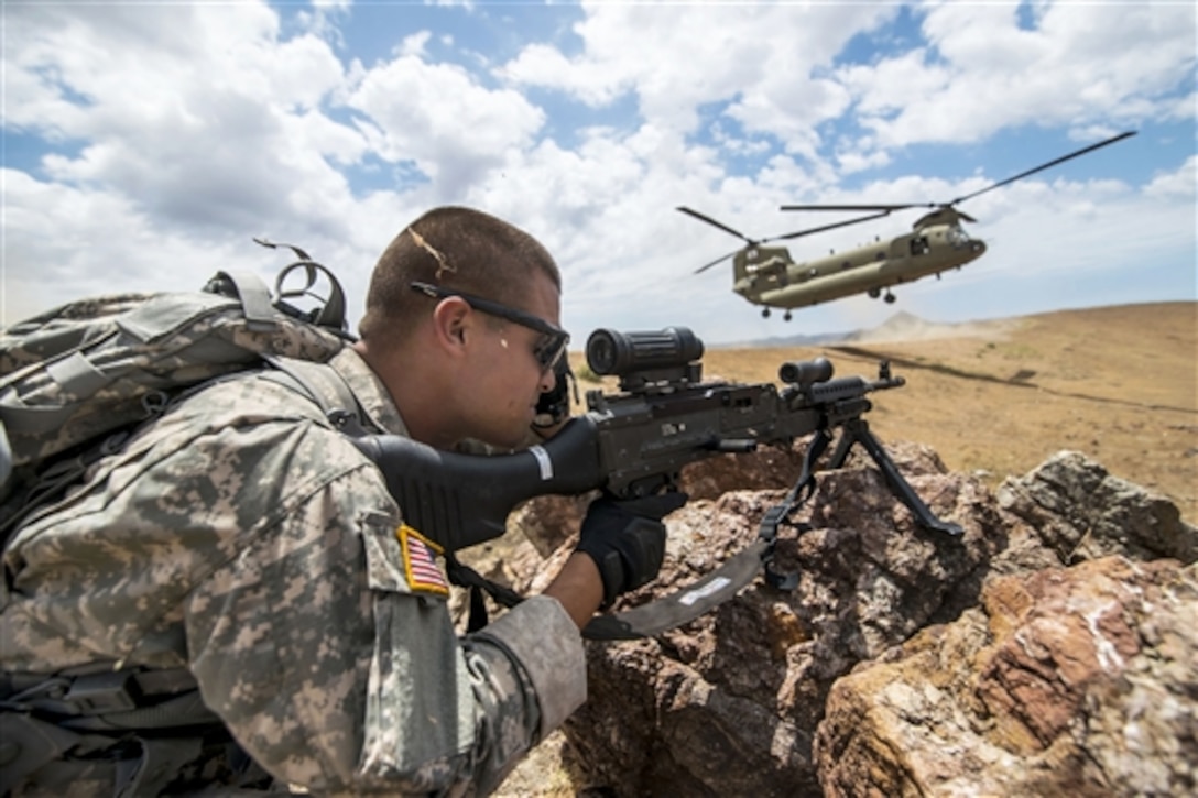 A soldier covers a sector of fire after off-loading from a CH-47 Chinook helicopter as he participate in an air assault landing during a sapper leader course on Camp San Luis Obispo Military Installation, Calif., July 18, 2015. The soldiers are reservists assigned to the 374th Engineer Company. The unit is grading its soldiers on various events to determine who will earn a spot on a "merit list" to attend a sapper leader course on Fort Leonard Wood, Mo.