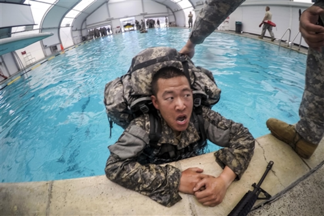 A soldier takes a breather after swimming 25 meters during combat water survival training on Fort Hunter Liggett, Calif., July 17, 2015. The soldier is a reserve combat engineer assigned to the 374th Engineer Company, which is grading its soldiers to determine who will earn a spot on a "merit list" to attend a sapper leader course on Fort Leonard Wood, Mo.