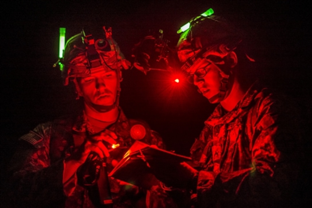 Army Cpl. Brock O'Shaughnessy and Cpl. James Farran orient themselves on a map during a night navigation course through the hills and mountains of Camp San Luis Obispo Military Installation, Calif., July 15, 2015. O'Shaughnessy and Farran are reserve combat engineers assigned to the 374th Engineer Company, which is grading its soldiers to determine who will earn a spot on a "merit list" to attend a sapper leader course on Fort Leonard Wood, Mo.