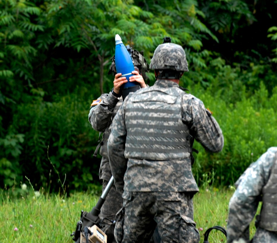 A Soldier Loads A Mortar Round During A Live fire Exercise Using M120 a-soldier-loads-a-mortar-round-during-a-live-fire-exercise-using-m120