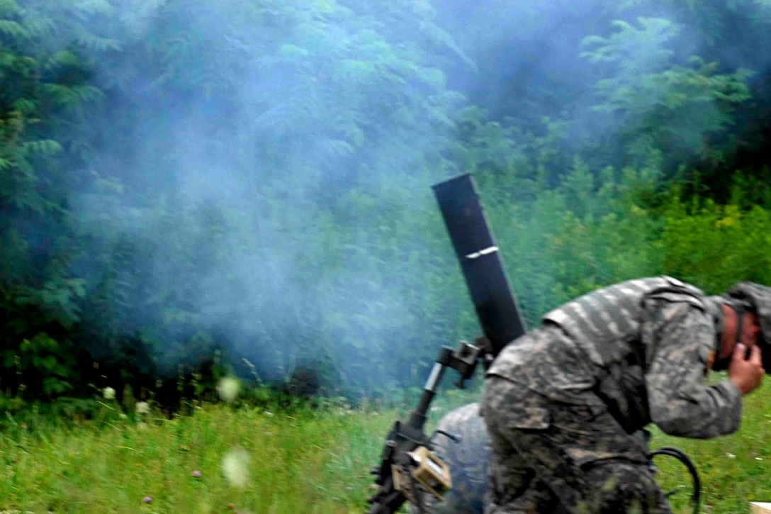 Soldiers fire a mortar round during a live-fire exercise using M120 and M224 mortars on Fort Drum, N.Y., July 14, 2015.