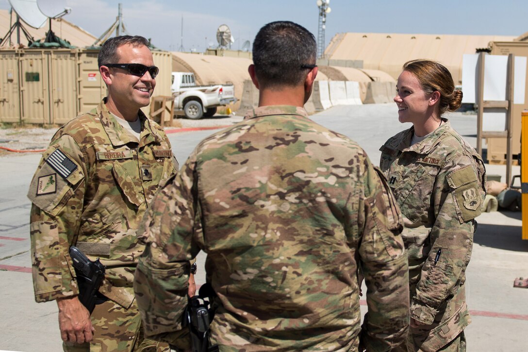 U.S. Air Force Brig. Gen. Dave Julazadeh, commander of 455th Air Expeditionary Wing, center, speaks with U.S. Air Force Lt. Col. Victor Pereira, left, commander of 83rd Expeditionary Rescue Squadron, and U.S. Air Force Capt. Meghan Strabala, officer in charge of 41st Expeditionary Helicopter Maintenance Unit, during an immersion tour on Bagram Airfield, Afghanistan, July 16, 2015.