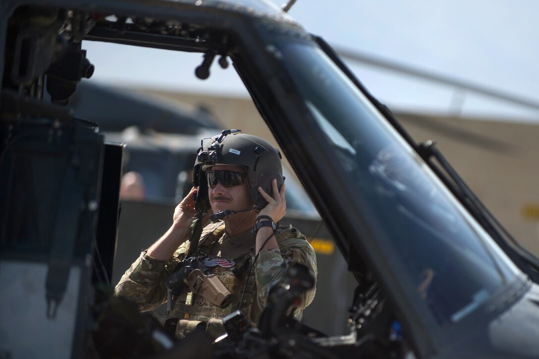 A U.S. Air Force HH-60 Pave Hawk helicopter pilot prepares for a training mission on Bagram Airfield, Afghanistan, July 16, 2015.