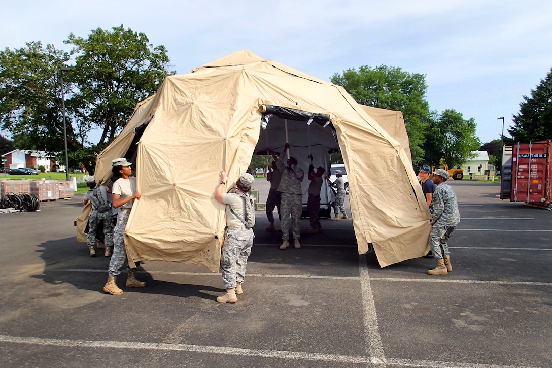 U.S. Army Reserve troops prepare tents for veterinary services during ...