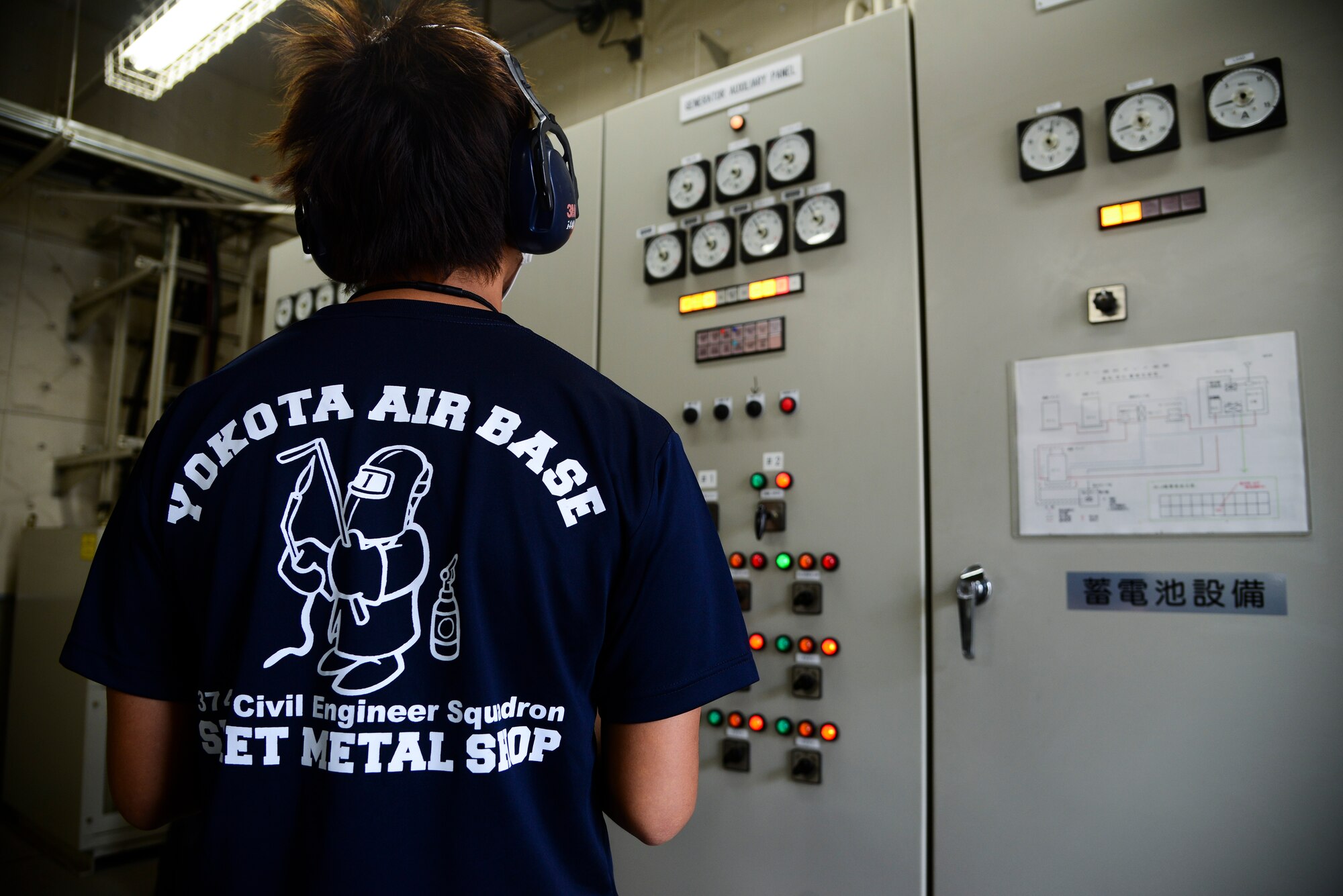 Kai Tsukamoto, 374th Civil Engineer Squadron electrical power production technician, checks the generator auxiliary panel to ensure a generator is properly working at Yokota Air Base, Japan, June 30, 2015. The generators section, which consists of approximately 90 generators spread throughout Yokota and geographically separated units, provides a backup power for mission-critical buildings. (U.S. Air Force photo by Senior Airman David Owsianka/Released)