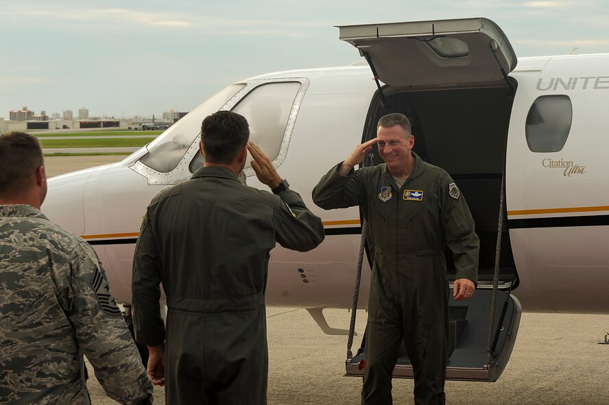 U.S. Air Force Lt. Gen. John Dolan, U.S. Forces Japan and 5th Air Force commander, is greeted by Brig. Gen. Barry Cornish, 18th Wing commander, and Chief Master Sgt. Charles Hoffman, 18th Wing command chief, during his visit to Okinawa July 22, 2015. During his tour he met with U.S. Department of Defense leadership and toured multiple installations to gain familiarity with the forces stationed on the island. He also spent time with Team Kadena Airmen and leadership to learn more about Kadena's position as the Keystone of the Pacific. (U.S. Air Force photo by Airman 1st Class Zackary A. Henry)