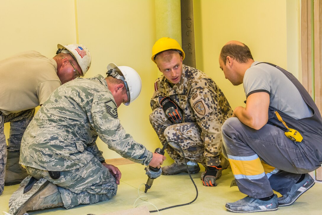 U.S. Airmen with the 139th Civil Engineer Squadron, Missouri Air National Guard, work along side soldiers from the Latvian National Armed Forces for the reconstruction of the Naujenu Orphanage near Daugavpils, Latvia, July 20, 2015.  The 139th CE was participating in the Humanitarian Civic Assistance project that pairs units training requirements with humanitarian needs.  (U.S. Air National Guard photo by Senior Airman Patrick P. Evenson/Released)