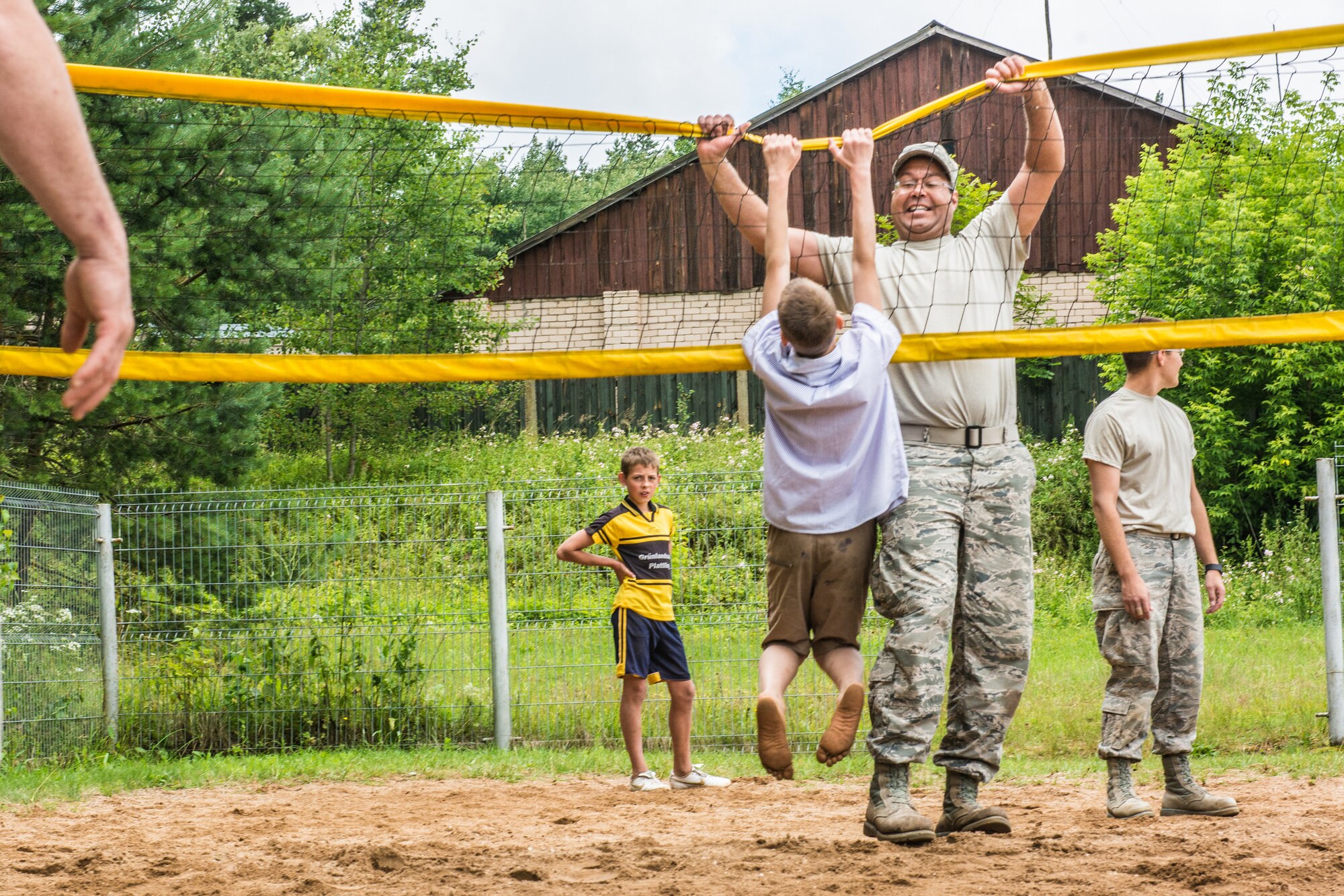 U.S. Air Force Staff Sgt. Matthew Mays, an engineering assistant with the 139th Civil Engineer Squadron, Missouri Air National Guard, plays with a Latvian orphan during a volleyball game at the Naujenu Orphanage near Daugavpils, Latvia, July 20, 2015. The Airmen were renovating the orphanage as part of a Humanitarian Civic Assistance project that pairs units training requirements with humanitarian needs. (U.S. Air National Guard photo by Senior Airman Patrick P. Evenson/Released)