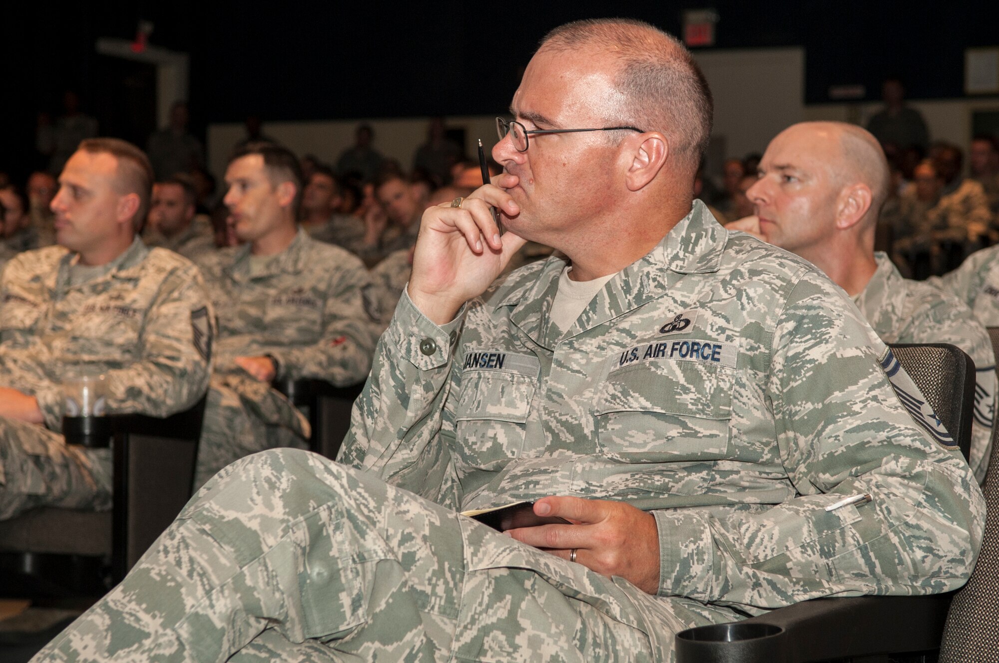 Senior Master Sgt. Robert Jansen, 4th Operations Support Squadron radar approach control chief controller, listens to a brief about upcoming changes to the Enlisted Evaluation System and Weighted Airman Promotion System, July 21, 2015, at Seymour Johnson Air Force Base, North Carolina. In addition to changes, the briefing outlined upcoming changes and allowed Airmen to ask questions. (U.S. Air Force photo/Airman Shawna L. Keyes)
