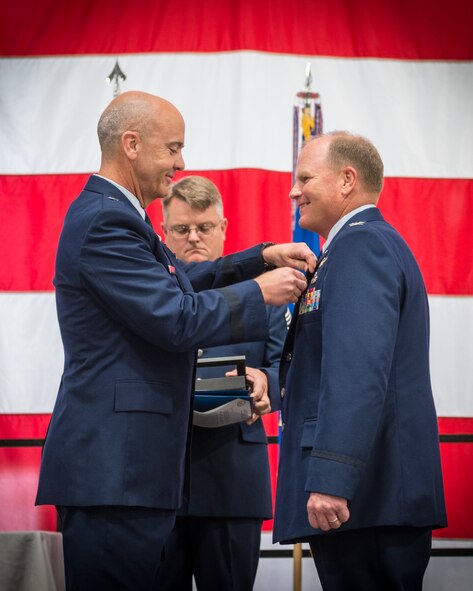 Brig. Gen. T. Glenn Davis, Mobilization Assistant To The Commander Air Force Life Cycle Management Center, presents Col. Cam LeBlanc, 934th Maintenance Group commander, with the Legion of Merit Award during his retirement ceremony.  Colonel LeBlanc retired after over 40 years of service Sunday of the July unit training assembly weekend at the Minneapolis-St. Paul Air Reserve Station, Minn.  (U.S. Air Force photo by Shannon McKay/Released)