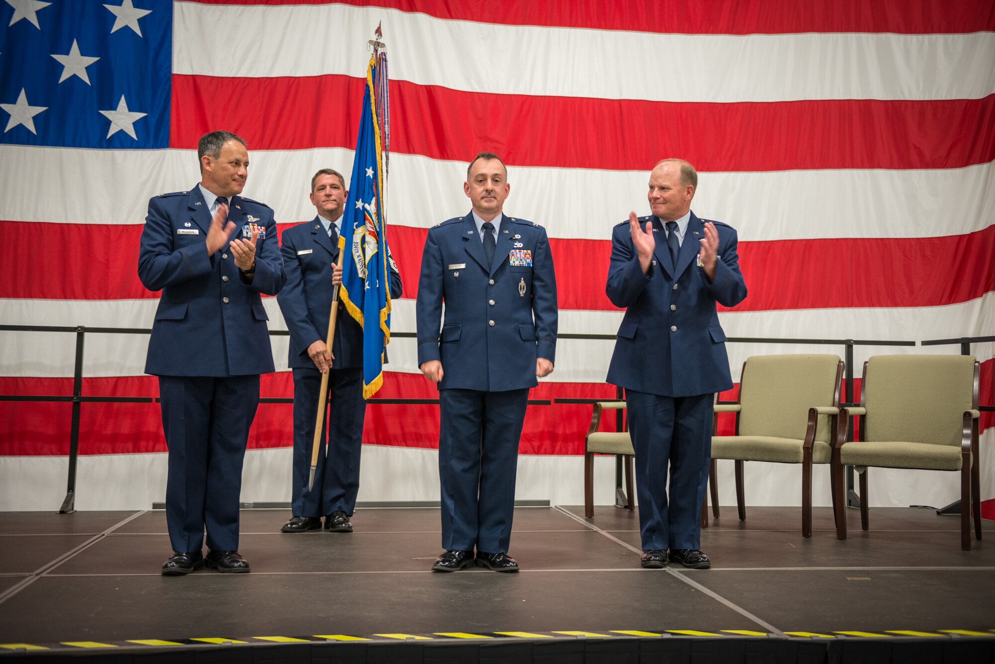 Col. Todd McCubbin (left), 934th Airlift Wing commander, and Col. Cam LeBlanc (right), 934th Maintenance Group commander, congratulate and welcome Col. Erik Sutcliffe (center) as the new 934 MXG commander as part of a change of command ceremony during the July unit training assembly weekend at the Minneapolis-St. Paul Air Reserve Station, Minn.  This is Sutcliffe's second time being stationed at the 934 AW as LeBlanc retires after over 40 years of service.  (U.S. Air Force photo by Shannon McKay/Released)