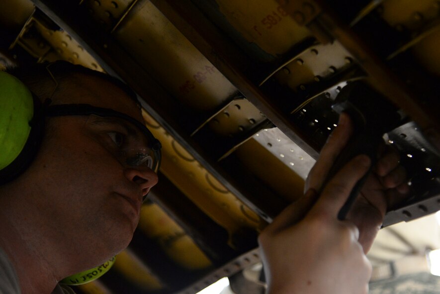 Staff Sgt. Eric Cote, 2nd Maintenance Squadron aircraft structural maintenance craftsman, uses a bucking bar to form a rivet inside a hole on an upper body cowling on Barksdale Air Force Base, La., July 20, 2015. The cowling is placed around the engine of a B-52 Stratofortress to protect it from debris. (U.S. Air Force photo/Senior Airman Jannelle Dickey) 