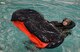 A B-52 Stratofortress aviator attempts to turn over a life raft during water survival training in Shreveport, La., July 21, 2015. Aviators receive triennial refresher training on how to release from their parachutes, enter a life raft and rescue cage. (U.S. Air Force photo/Staff Sgt. Benjamin Gonsier)