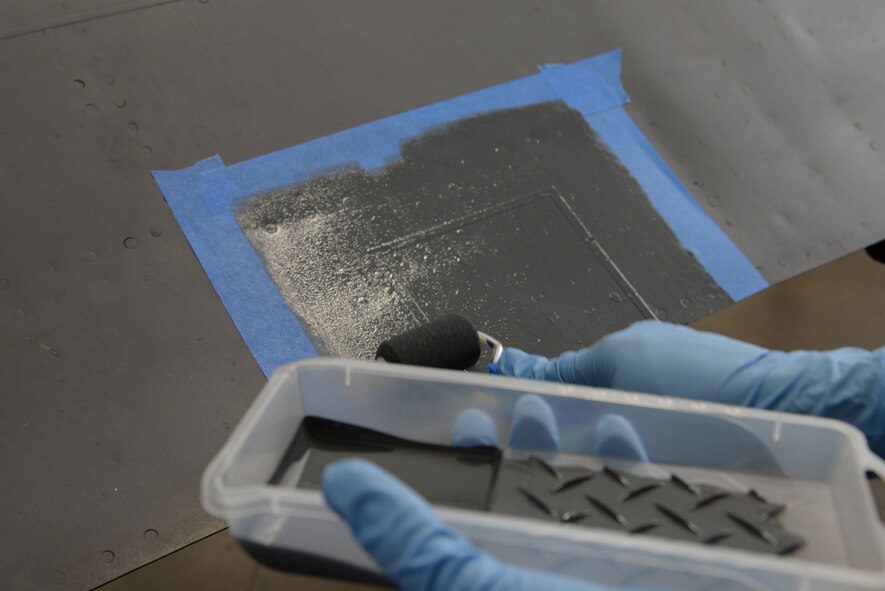 Senior Airman Dylan Fox, 707th Maintenance Squadron aircraft structural maintenance journeyman, paints the skin repair on an upper body cowling on Barksdale Air Force Base, La., July 20, 2015. Painting parts of the B-52 Stratofortress is just one responsibility of sheet metal Airmen. The fabrication flight consists of three units to include sheet metal, metals technology and nondestructive inspection. (U.S. Air Force photo/Senior Airman Jannelle Dickey)