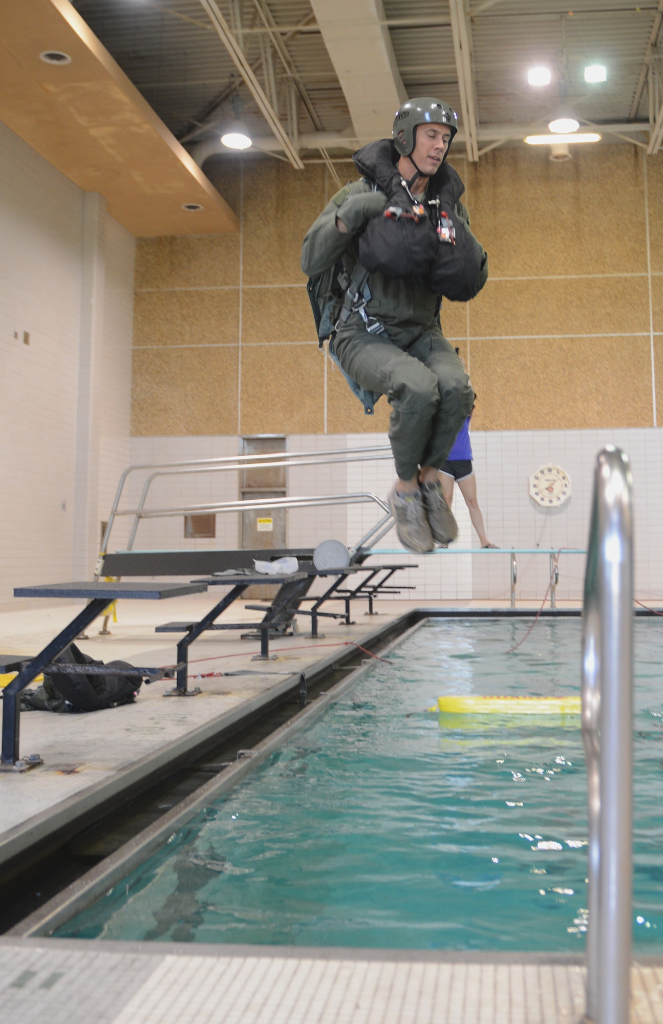 Maj. Josh Holmes, 2nd Operations Support Squadron director of operations, jumps into a pool in Shreveport, La., July 21, 2015. Aircrew members were taught basic survival skills to include how to operate a life raft, what fish can be used for human consumption and what to do in the event of a rescue. (U.S. Air Force photo/Staff Sgt. Benjamin Gonsier)