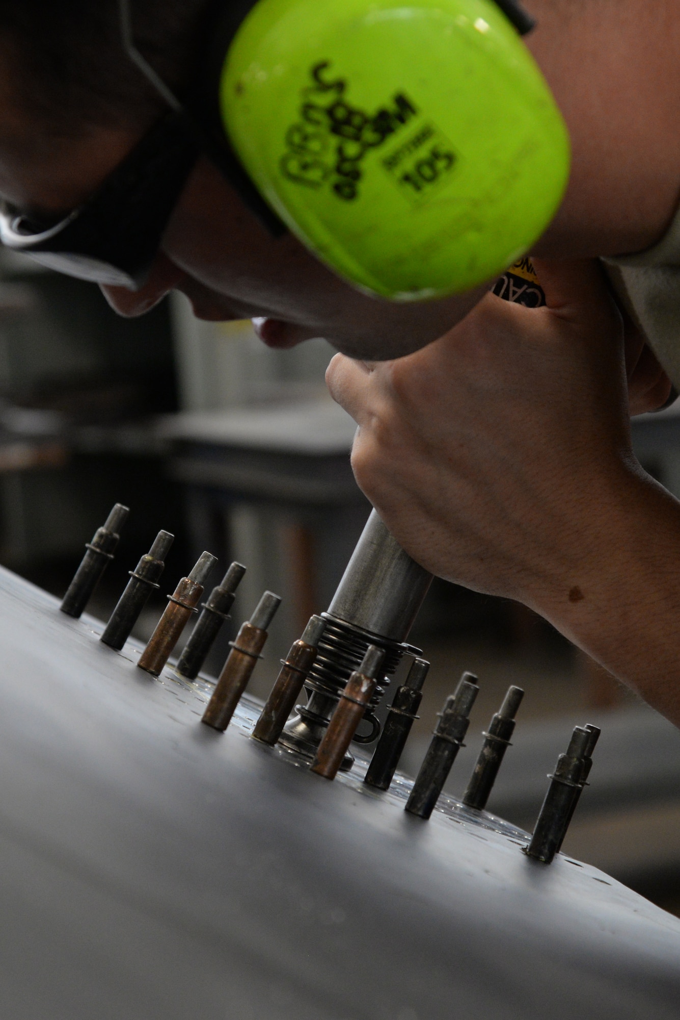 Senior Airman Dylan Fox, 707th Maintenance Squadron aircraft structural maintenance journeyman, drills rivets into an upper body cowling on Barksdale Air Force Base, La., July 20, 2015. Airmen from the 707th and 2nd MXS work together as part of the Total Force Integration program. (U.S. Air Force photo/Senior Airman Jannelle Dickey)