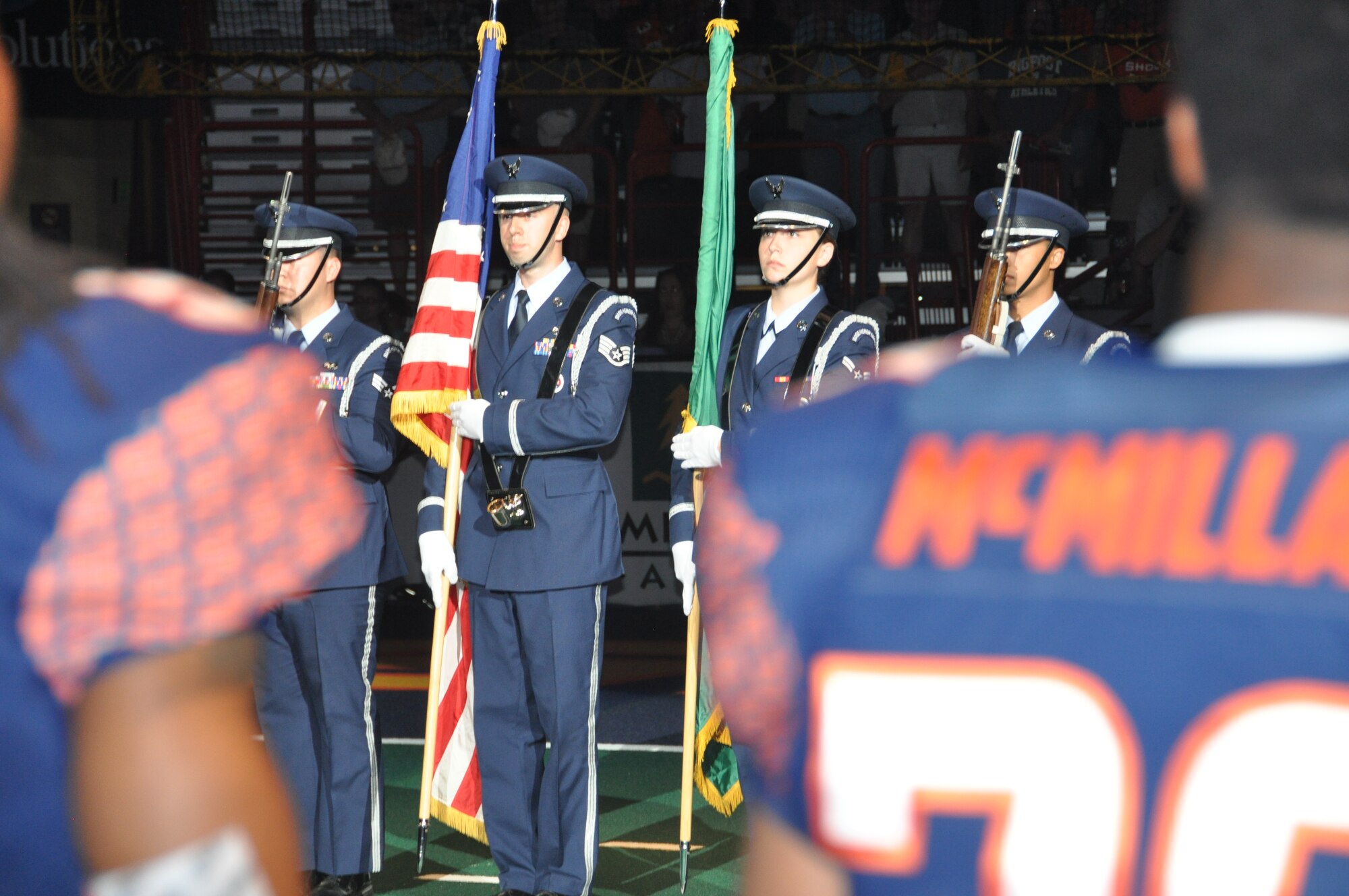Fairchild AFB Honor Guard members present the colors at a Spokane Shock football game July 17, 2015, at the Spokane Veterans Memorial Arena in Spokane, Wash. The honor guard is a congressionally-mandated program to provide well trained, highly professional members to honor and carry out the primary mission of rendering honors. (U.S. Air Force photo/2nd Lt. Shelley Gregory)