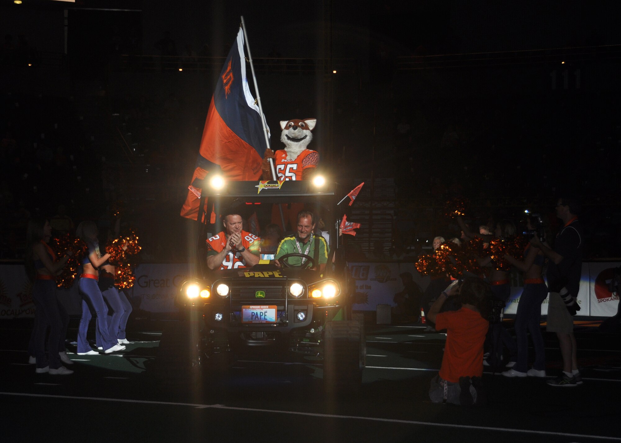 Col. Brian McDaniel, 92nd Air Refueling Wing commander, rides onto the field at the beginning of a Spokane Shock football game to toss the coin, July 17, 2015, at the Spokane Veterans Memorial Arena in Spokane, Wash. McDaniel was the Spokane Shock honorary team captain. (U.S. Air Force photo/2nd Lt. Shelley Gregory)
