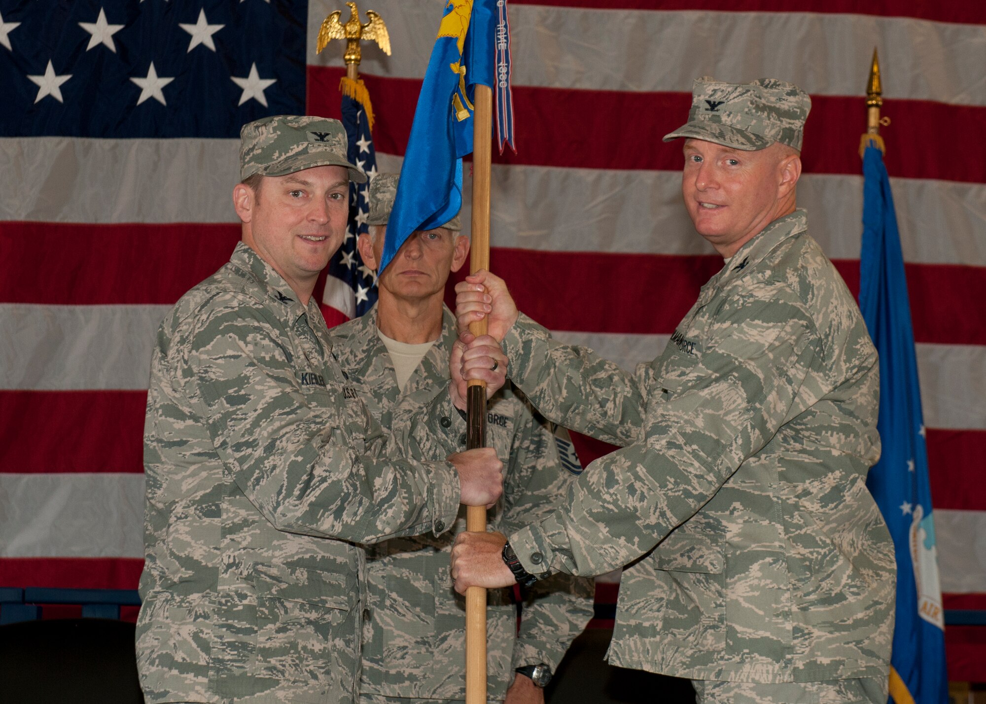 Col. Robert Kiebler, the 49th Wing commander, turns over command of the 49th Materiel Maintenance Group to Col. Joseph Moehlmann, the incoming 49th MMG commander, at Holloman Air Force Base, N.M. on July 1. The 49th MMG is the Air Force’s only Basic Expeditionary Airfield Resources base, also known as BEAR base, which can supply responsive expeditionary airfield resources and expertise to support deployed military members as well as humanitarian efforts. (U.S. Air Force photo by 49th Wing Public Affairs Office)