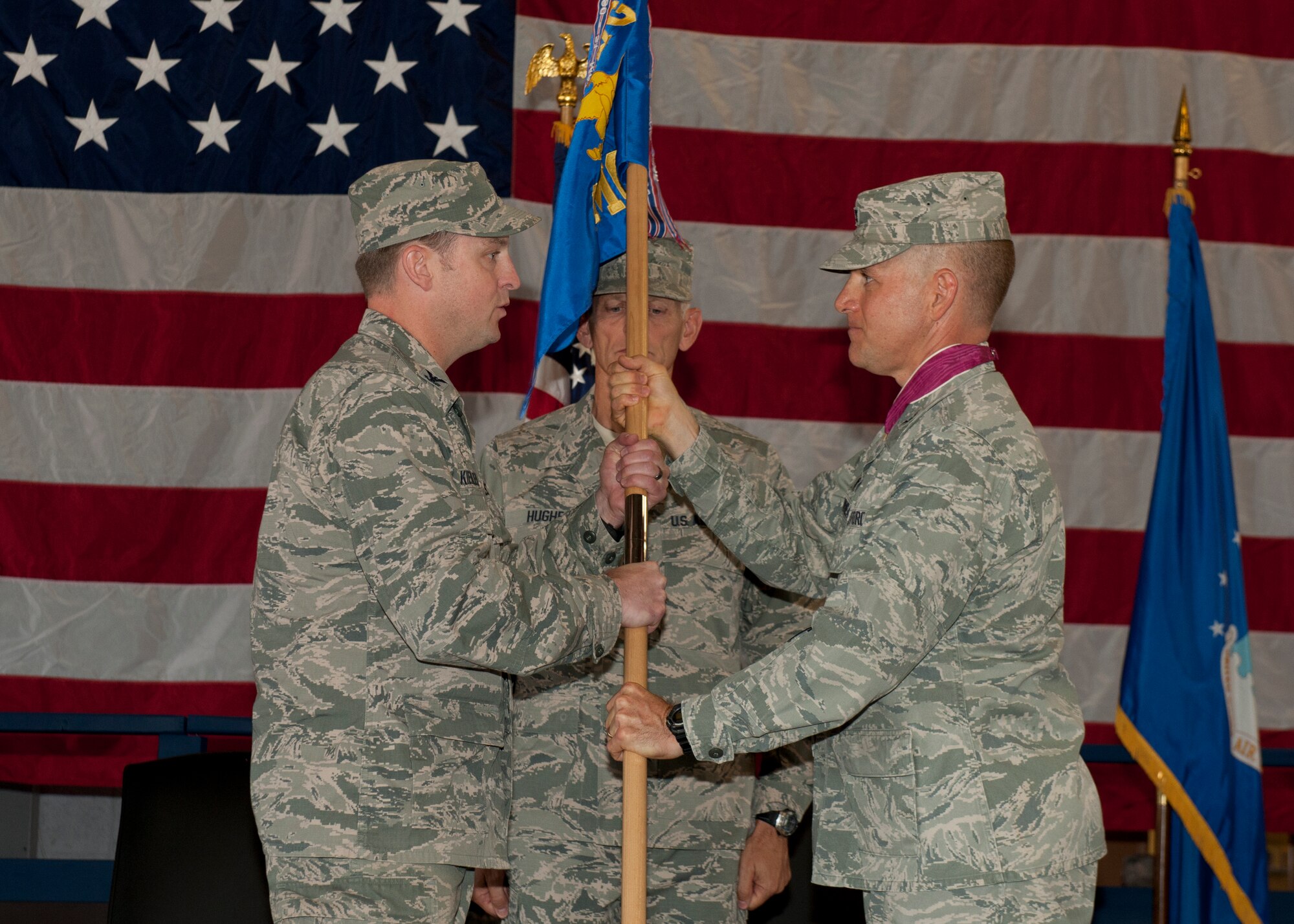 Colonel Robert Kiebler, the 49th Wing commander, receives the 49th MMG guidon here on July 1 from Col. Robert Letourneau, the 49th Materiel Maintenance Group outgoing commander, relinquishing his command of the 49th MMG at Holloman Air Force Base, N.M. The 49th MMG is the Air Force’s only Basic Expeditionary Airfield Resources base, also known as BEAR base, which can supply responsive expeditionary airfield resources and expertise to support deployed military members as well as humanitarian efforts. (U.S. Air Force photo by 49th Wing Public Affairs Office)