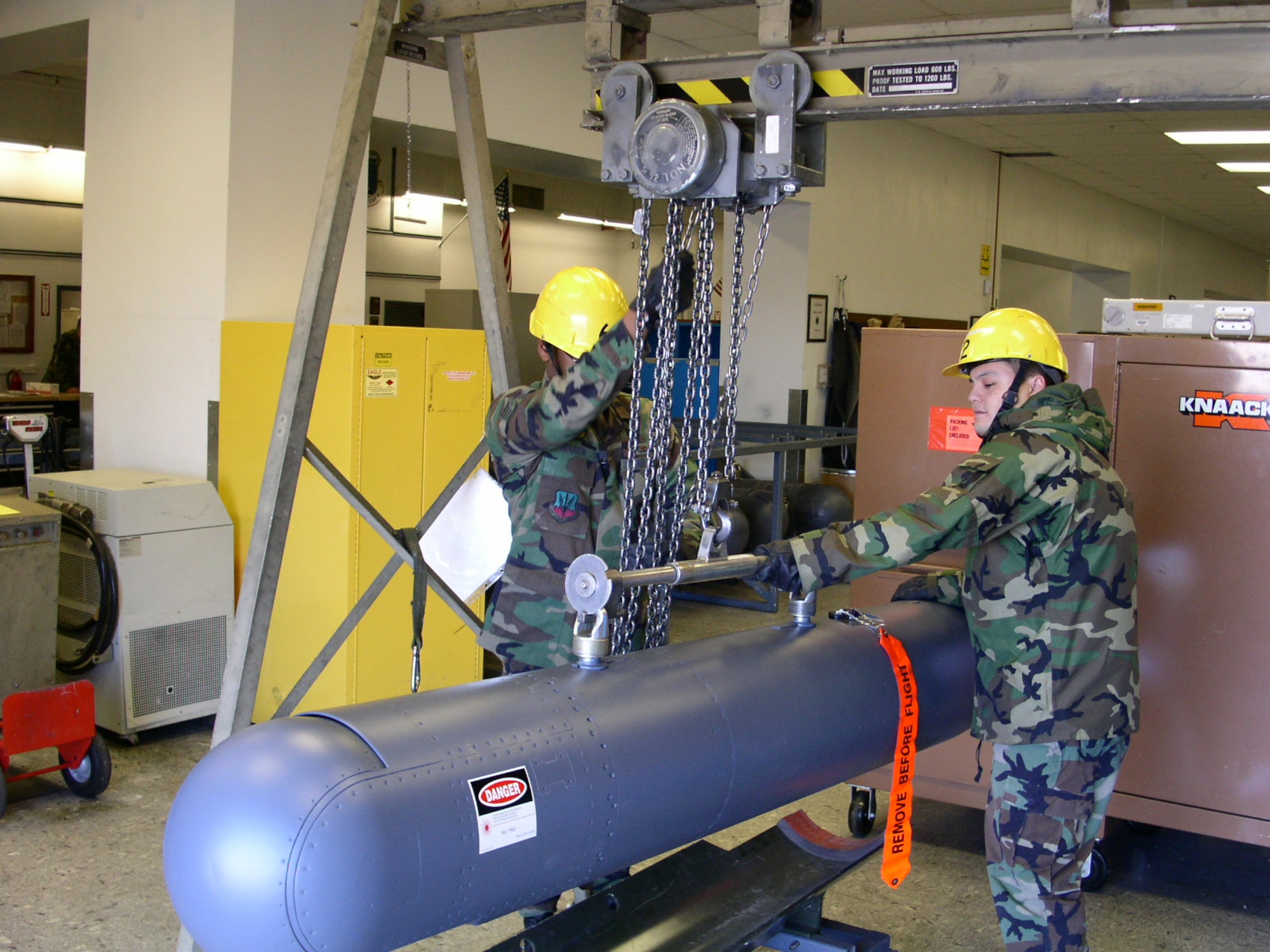 Airmen from the 388th Component Maintenance Squadron's LANTIRN pod shop hoist a targeting pod.
