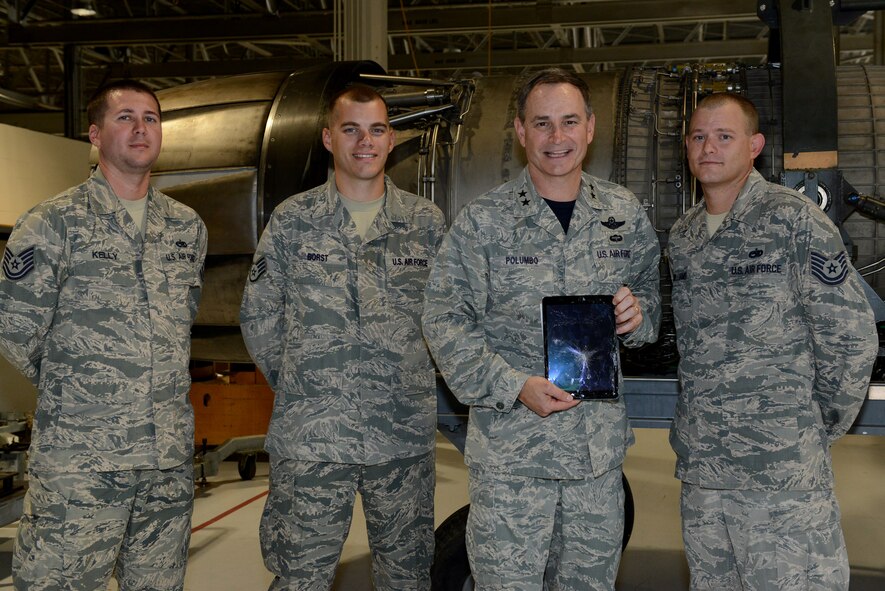 U.S. Air Force Maj. Gen. H. D. Polumbo Jr., Ninth Air Force commander, displays a device the Air Force Repair Enhancement Program Airmen can restore to working condition at Shaw Air Force Base, S.C., July 17, 2015. The AFREP Airmen saved the 20th Fighter Wing more than $2.03 million in fiscal year 2014, which created additional funds for gear and equipment needed around base. (U.S. Air Force photo by Senior Airman Diana M. Cossaboom/Released)