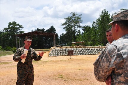 SOTO CANO AIR BASE, Honduras – U.S. Marine Corps 1st Lt. Tyler Martin, Special Purpose Marine Air Ground Task Force-Southern Command engineer detachment officer in charge, briefs Maj. Gen. K. K. Chinn, U.S. Army South commanding general, about Marine construction projects at Mocoron, Honduras, during the general’s visit July 18, 2015. In addition to building barracks and improving the runway at Mocoron, the Marines are deployed throughout Honduras, Belize, El Salvador and Guatemala, where they are building partnerships with host-nation militaries and conducting humanitarian assistance missions. (U.S. Air Force photo by Capt. Christopher Love)