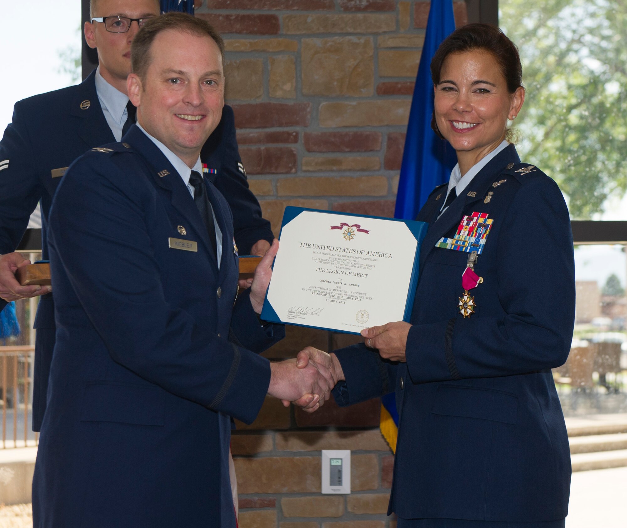 Colonel Robert Kiebler, the 49th Wing commander, and Col. Leslie Knight, the 49th Medical Group outgoing commander, pose for a photo after Knight was presented the Legion of Merit medal during the 49th MDG change of command ceremony at Holloman Air Force Base, N.M. on July 21. During the ceremony, Knight relinquished command of the 49th MDG to Col. Paul Willingham. (U.S. Air Force photo by Airman 1st Class Emily A. Kenney)