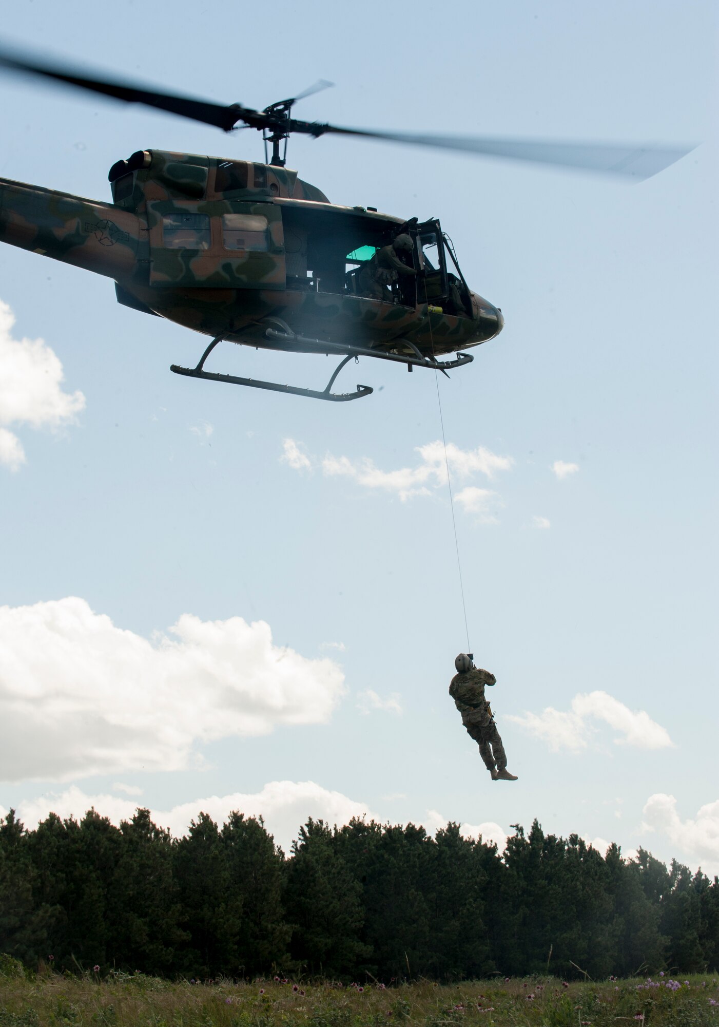 Airman 1st Class William Barron, 791st Missile Security Forces Squadron tactical response force member, is hoisted into a UH-N1 Helicopter near Garrison, N.D., July 20, 2015. Barron and the helicopter crew were practicing search and rescue tactics for the upcoming Global Strike Challenge competition in Guernsey, Wyo. (U.S. Air Force photo/Senior Airman Stephanie Morris)
