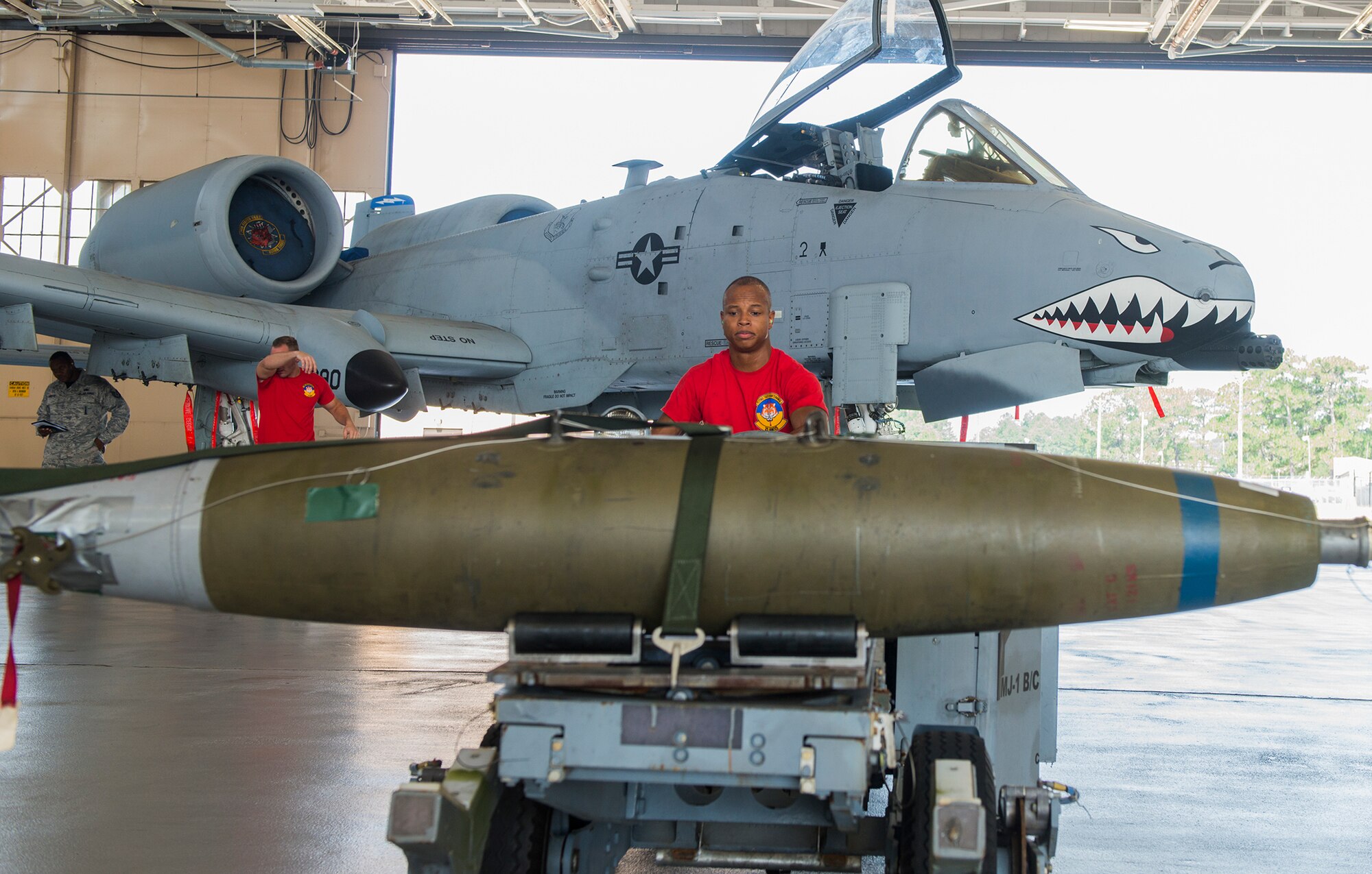 U.S. Air Force Senior Airman Keelend Smith, 75th Aircraft Maintenance Unit weapons load crew member, moves a bomb during the load crew of the quarter competition July 17, 2015, at Moody Air Force Base, Ga. The 74th and 75th AMUs faced off to determine the best load crew. (U.S. Air Force photo by Airman 1st Class Ceaira Tinsley/Released)