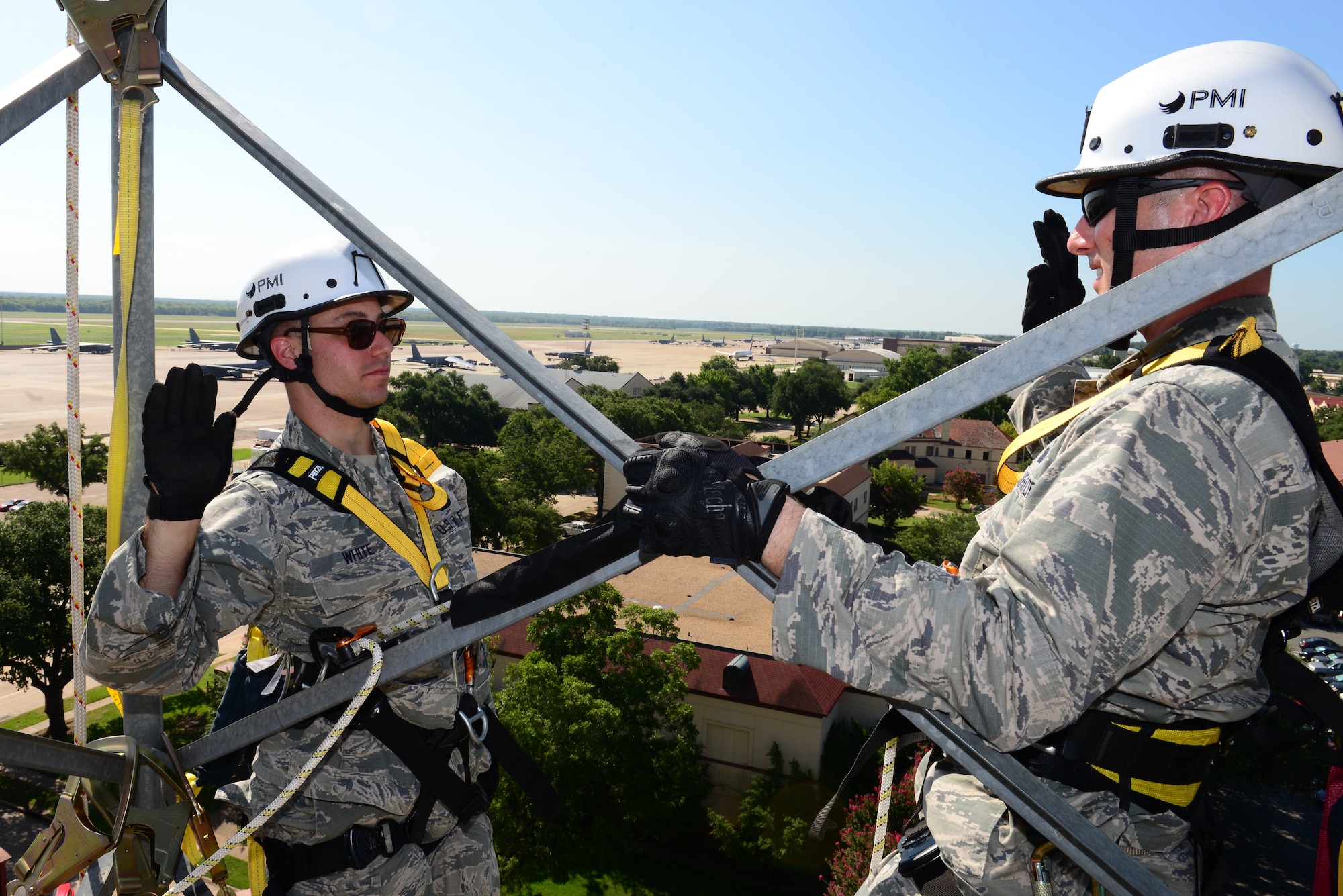 Staff Sgt. Michael White, 2nd Security Forces Squadron, reenlists atop a communication tower on Barksdale Air Force Base La., July 15, 2015. White had the unique opportunity to reenlist 150 feet high above the base that he helps defend. (U.S. Air Force Photo/Airman 1st Class Luke Hill)