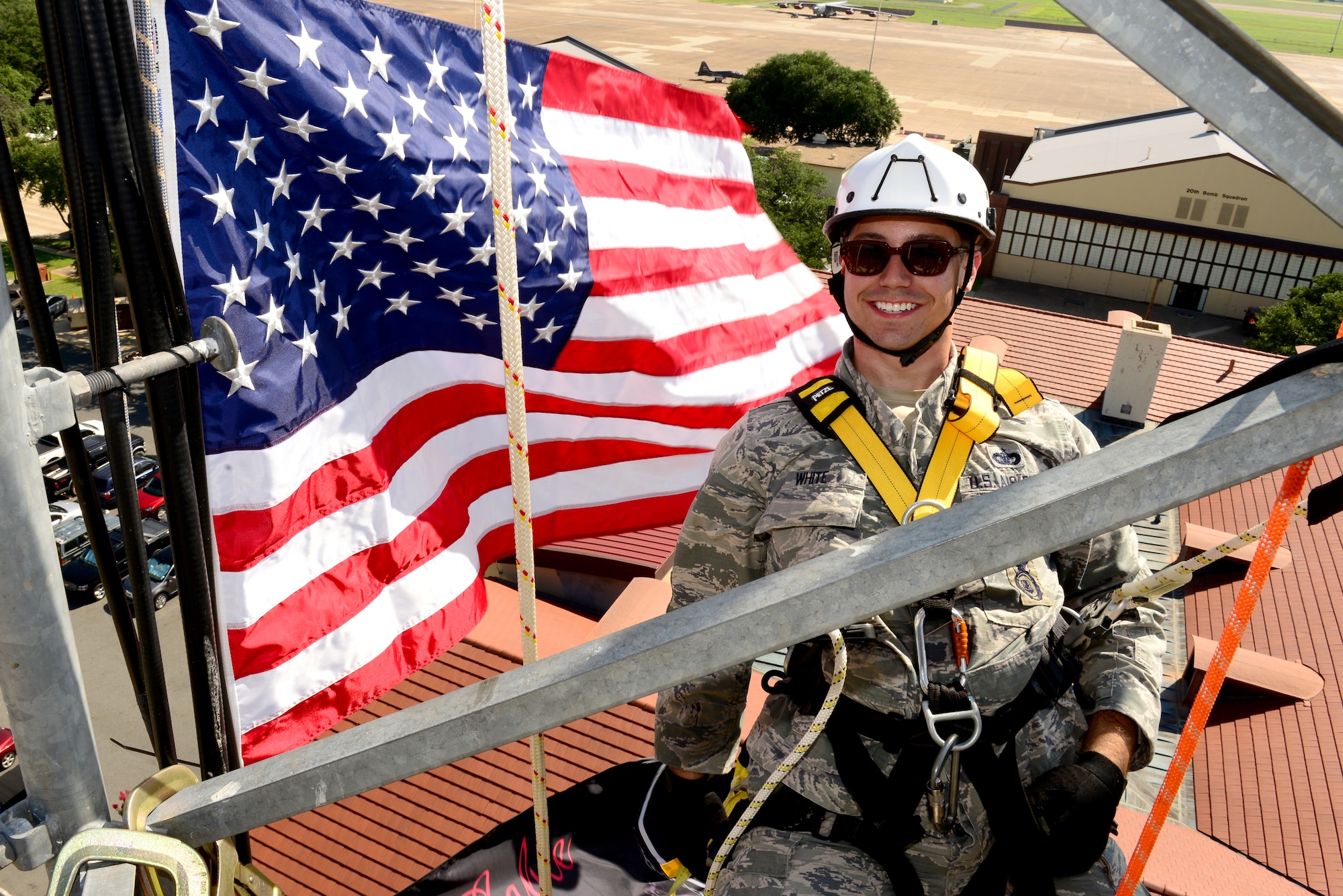 Staff Sgt. Michael White, 2nd Security Forces Squadron, poses for a photo on top of a communications tower on Barksdale Air Force, La., July 15, 2015. White had the unique opportunity to reenlist 150 feet high above the base that he helps defend. (U.S. Air Force Photo/Airman 1st Class Luke Hill)