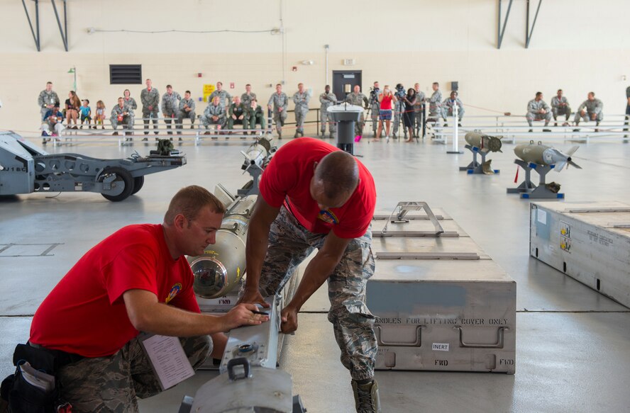 U.S. Air Force Staff Sgt. Tony Watson, 75th Aircraft Maintenance Unit weapons load team chief, and Senior Airman Keelend Smith, 75th AMU weapons load crew member, work together during the load crew of the quarter competition July 17, 2015, at Moody Air Force Base, Ga. The 74th and 75th AMUs have competed in the quarterly load completion seven years in a row. (U.S. Air Force photo by Airman 1st Class Ceaira Tinsley/Released)