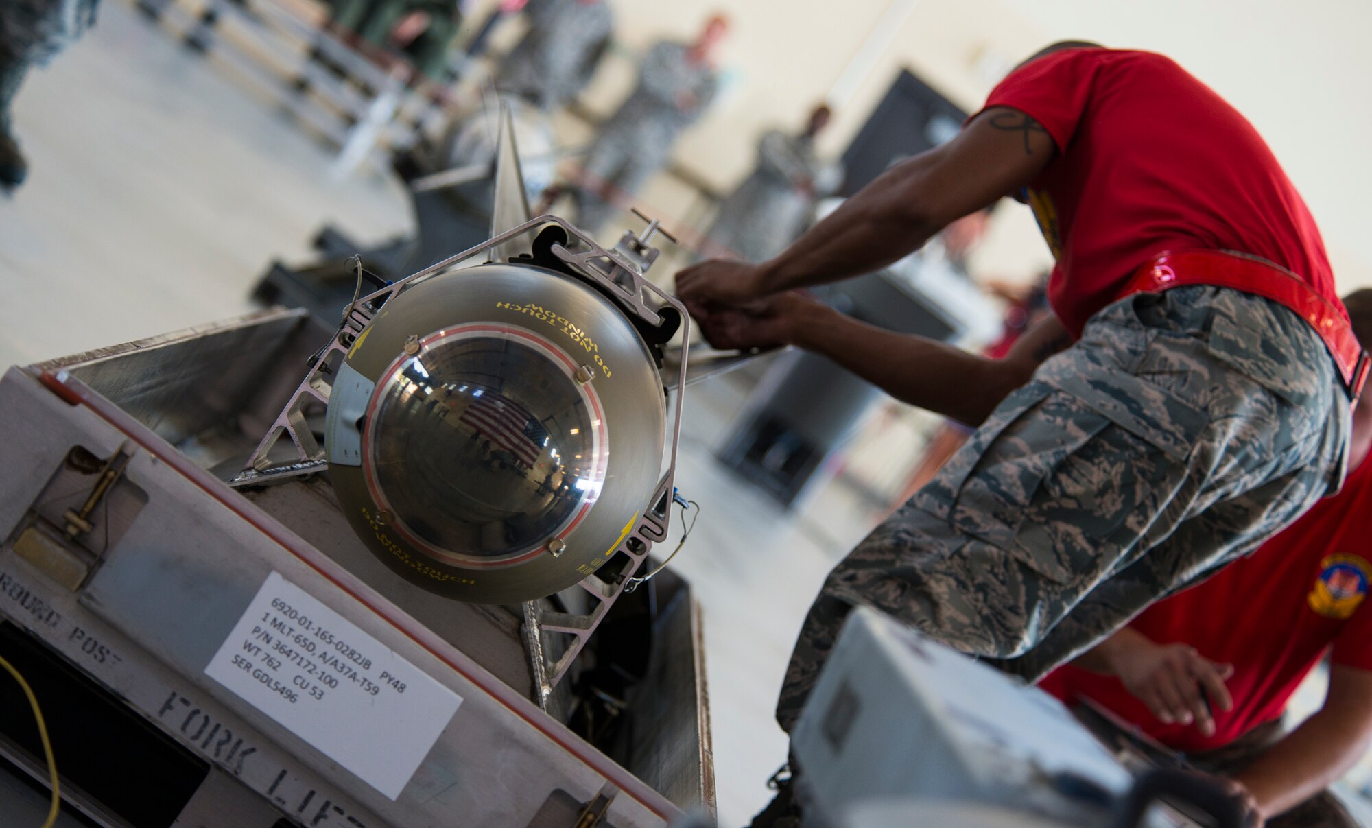 U.S. Air Force Senior Airman Keelend Smith, 75th Aircraft Maintenance Unit weapons load crew member, unlatches a bomb during the load crew of the quarter competition July 17, 2015, at Moody Air Force Base, Ga. The 75th and 74th AMUs were judged based on quick and efficient munitions loading onto the A-10C Thunderbolt II during the loading portion of the competition. (U.S. Air Force photo by Airman 1st Class Ceaira Tinsley/Released)