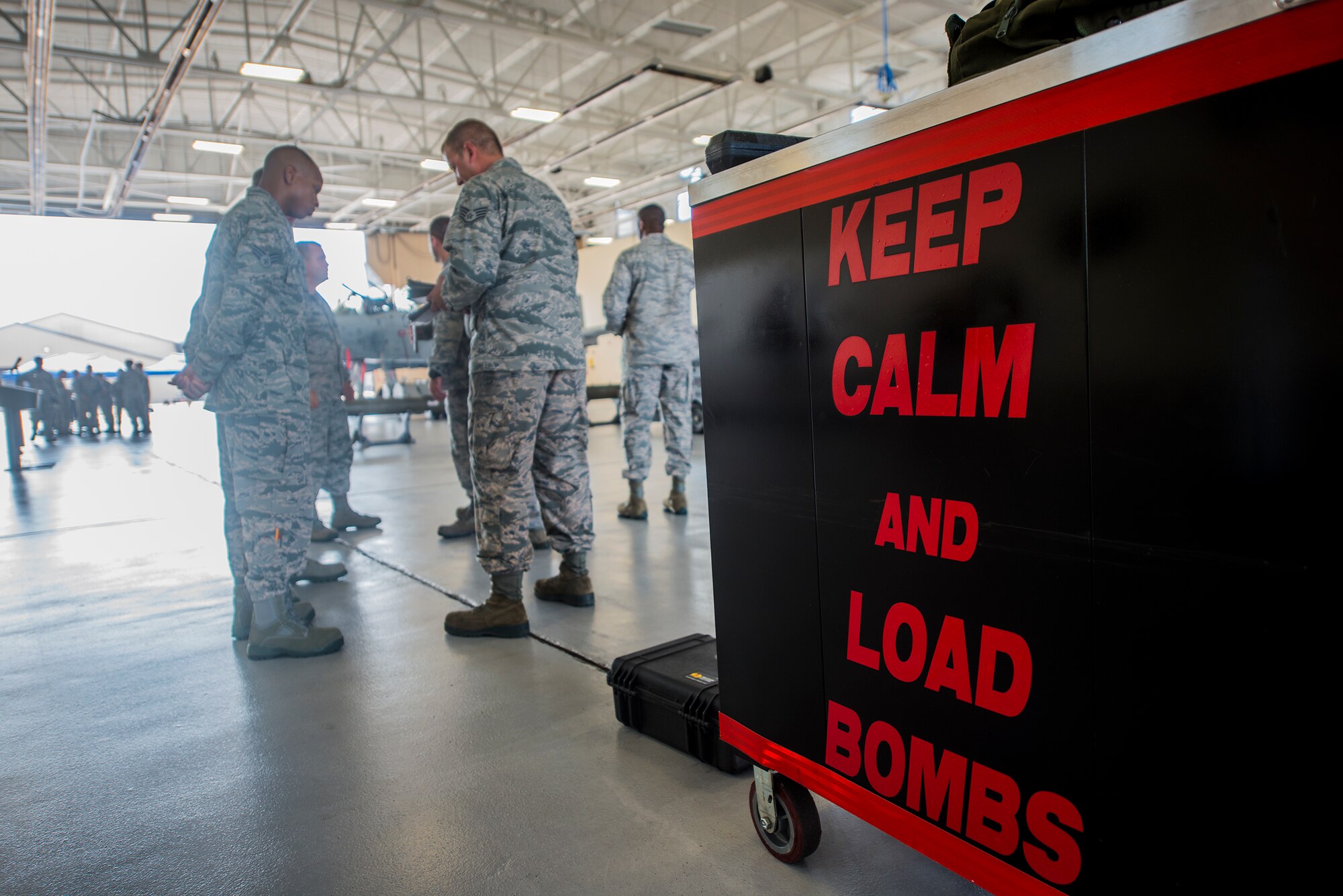 Members of the 75th Aircraft Maintenance Unit listen to the rules before the load crew of the quarter competition July 17, 2015, at Moody Air Force Base, Ga. The 75th AMU won for the second time this year. (U.S. Air Force photo by Airman 1st Class Ceaira Tinsley/Released)