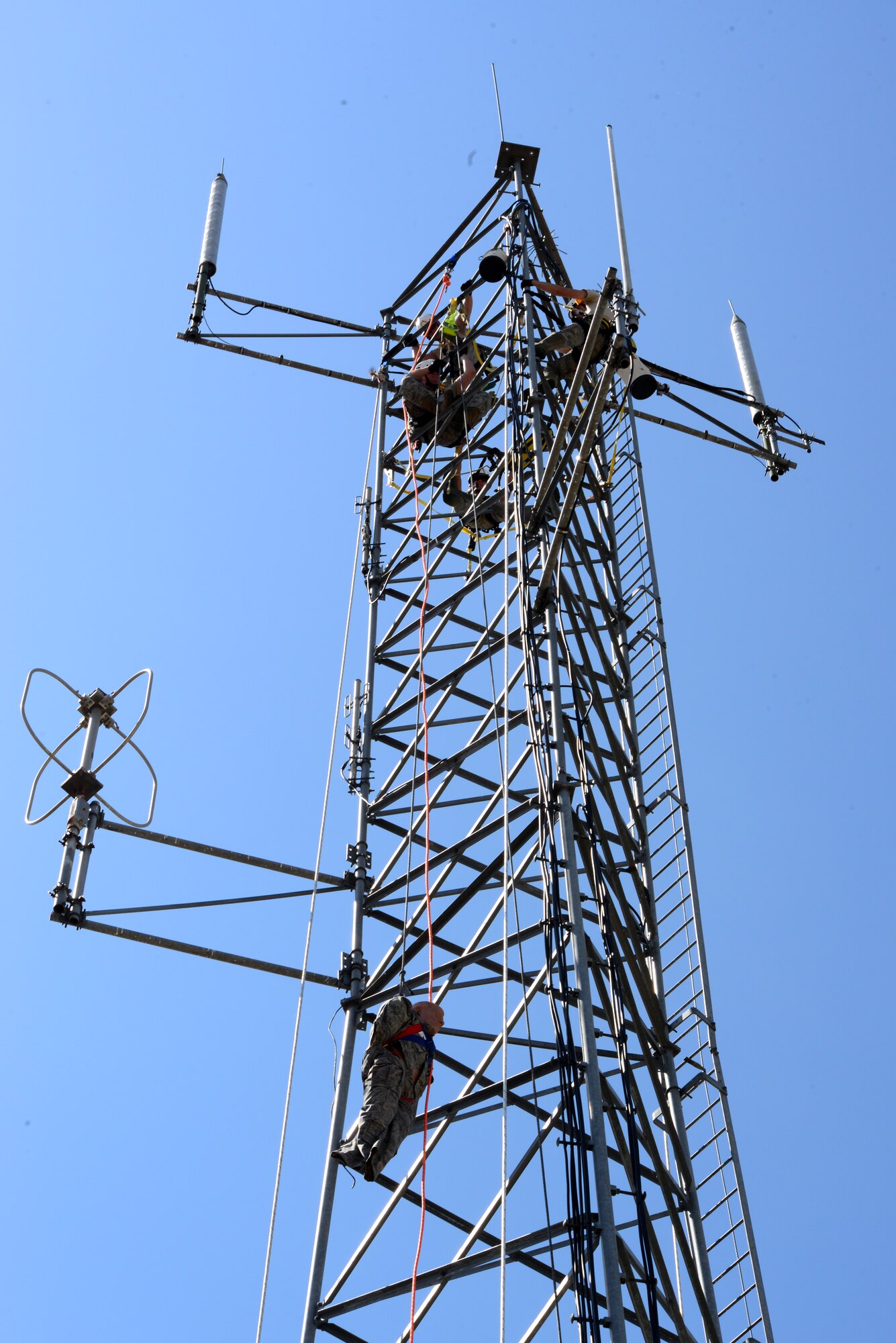 Airmen from 2nd Communication Squadron cable and antenna systems, lower a rescue dummy down a tower on Barksdale Air Force Base, La., July 15, 2015. The simulation is important in the event an Airman becomes ill or passes out, they can be moved to a safe location. (U.S. Air Force Photo/Airman 1st Class Luke Hill)