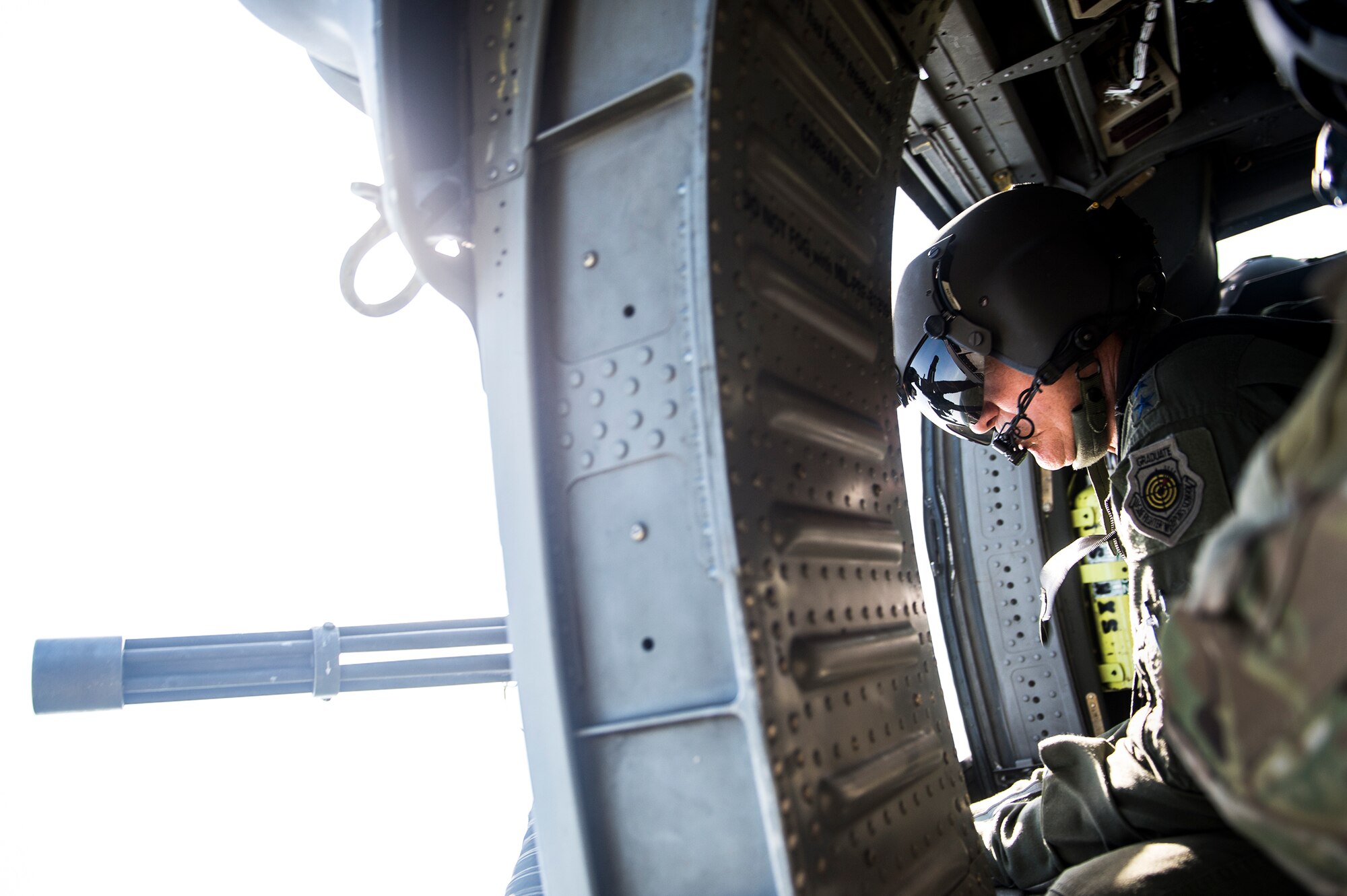 U.S. Air Force Gen. Hawk Carlisle, commander Air Combat Command, looks out the gunner’s door of a 41st Rescue Squadron HH-60G Pave Hawk July 15, 2015, over Moody Air Force Base, Ga. Airmen from the 41st RQS took Carlisle on a flight to allow a hands-on demonstration of a special missions aviators in-flight responsibilities. (U.S. Air Force photo by Senior Airman Ryan Callaghan/Released))