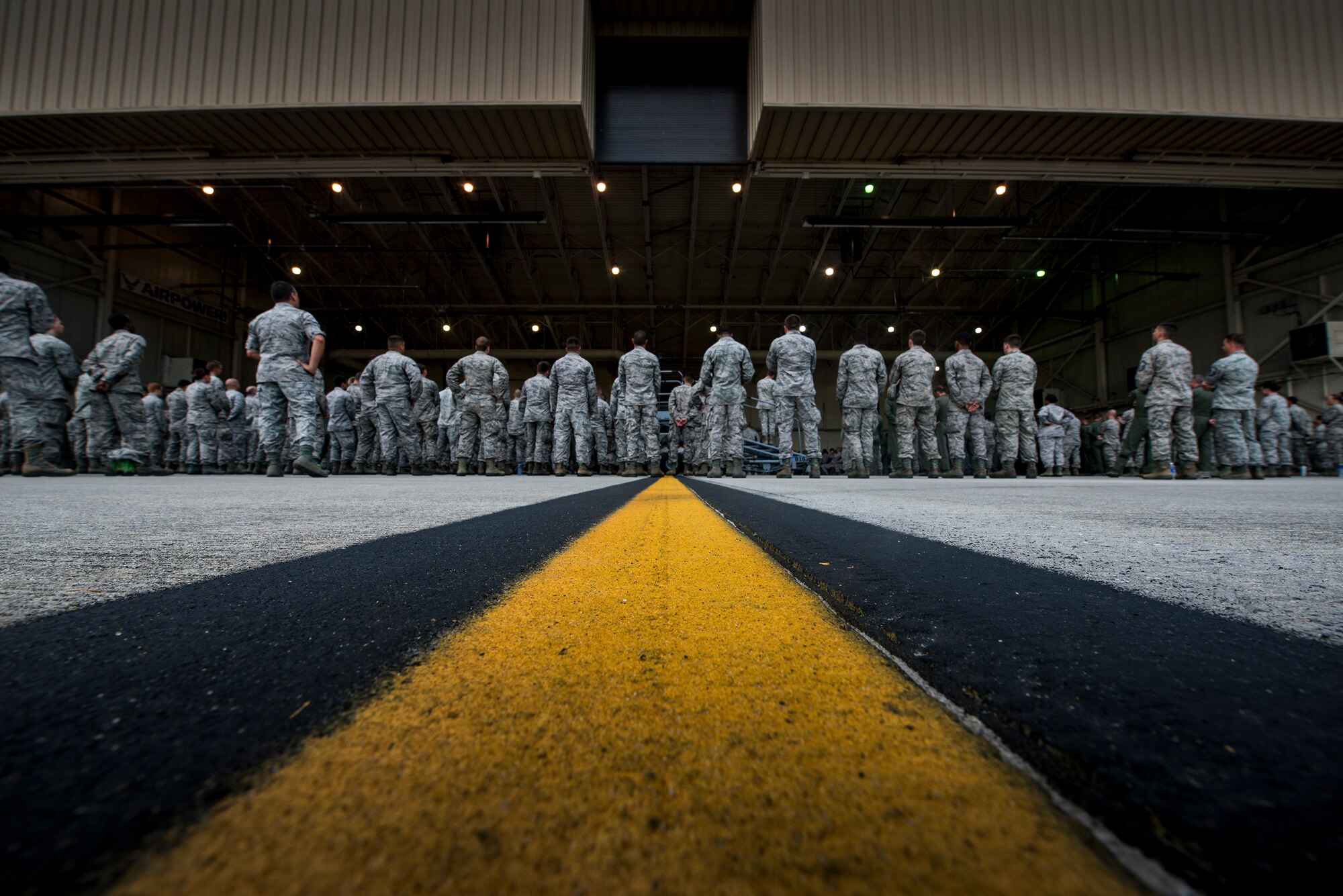 Airmen stand outside a hangar during a base all-call held by U.S. Air Force Gen. Hawk Carlisle, commander Air Combat Command, July 15, 2015, at Moody Air Force Base, Ga. During the all-call Carlisle addressed personnel changes and his vision for ACC. (U.S. Air Force photo by Senior Airman Ryan Callaghan/Released)