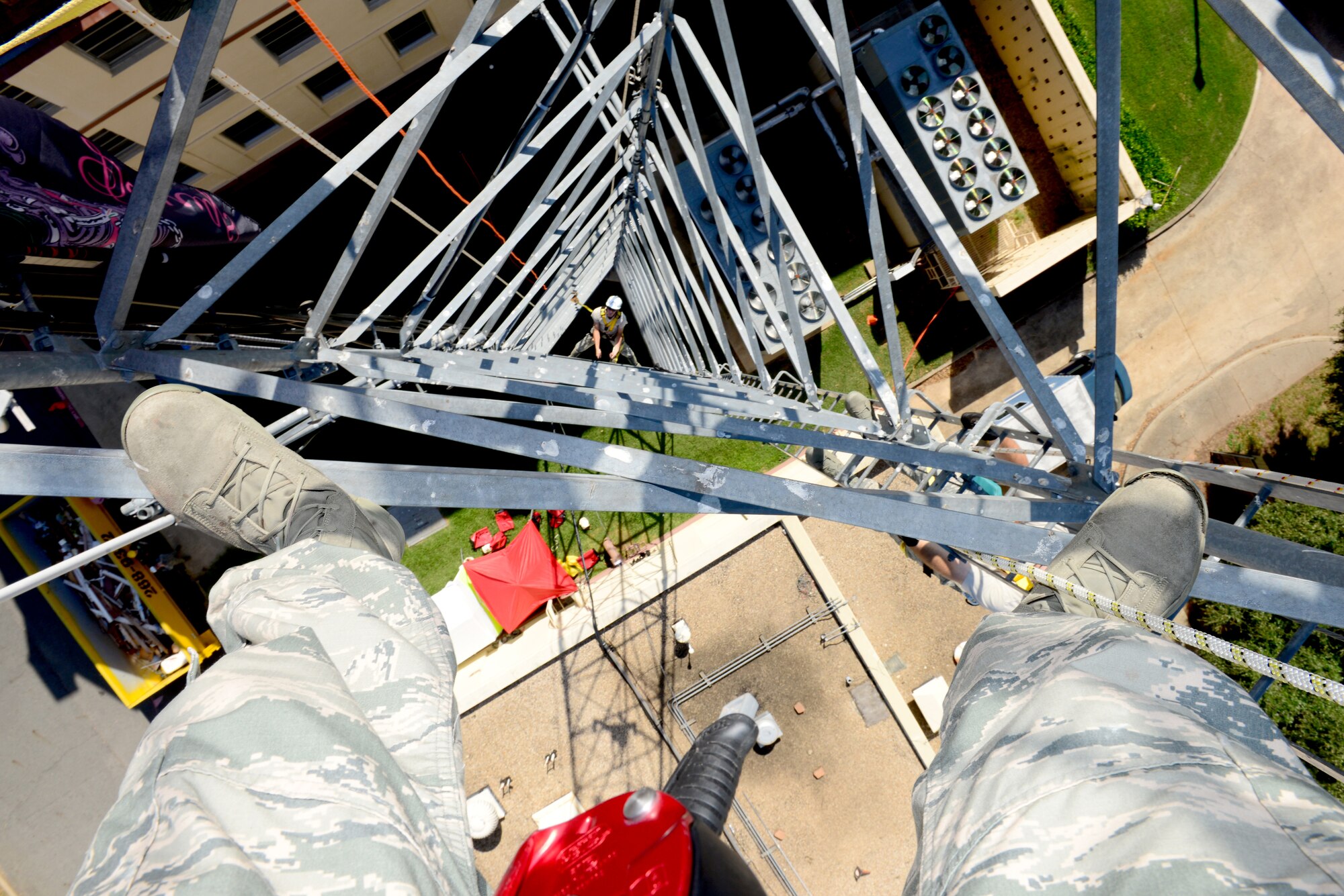 Airman 1st Class Chris Bailey, 2nd Communications Squadron cable and antenna systems maintainer, looks upward as he climbs a communication tower on Barksdale Air Force Base, La., July 15, 2015. Cable and antenna Systems Airmen must be aware of their surroundings and look out for falling objects. (U.S. Air Force Photo/Airman 1st Class Luke Hill)